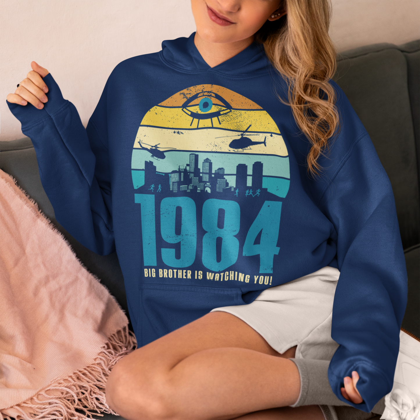 Introducing our George Orwell 1984 Hoodie with a bold "Big Brother is Watching" design! If you're a fan of Orwell's classic dystopian novel or just love thought-provoking literary references, this shirt is for you. The design features the iconic phrase "Big Brother is Watching" in small, bold letters, set against a stark sunset background. The lettering has a slightly distressed, vintage look, giving the shirt a cool, edgy vibe.