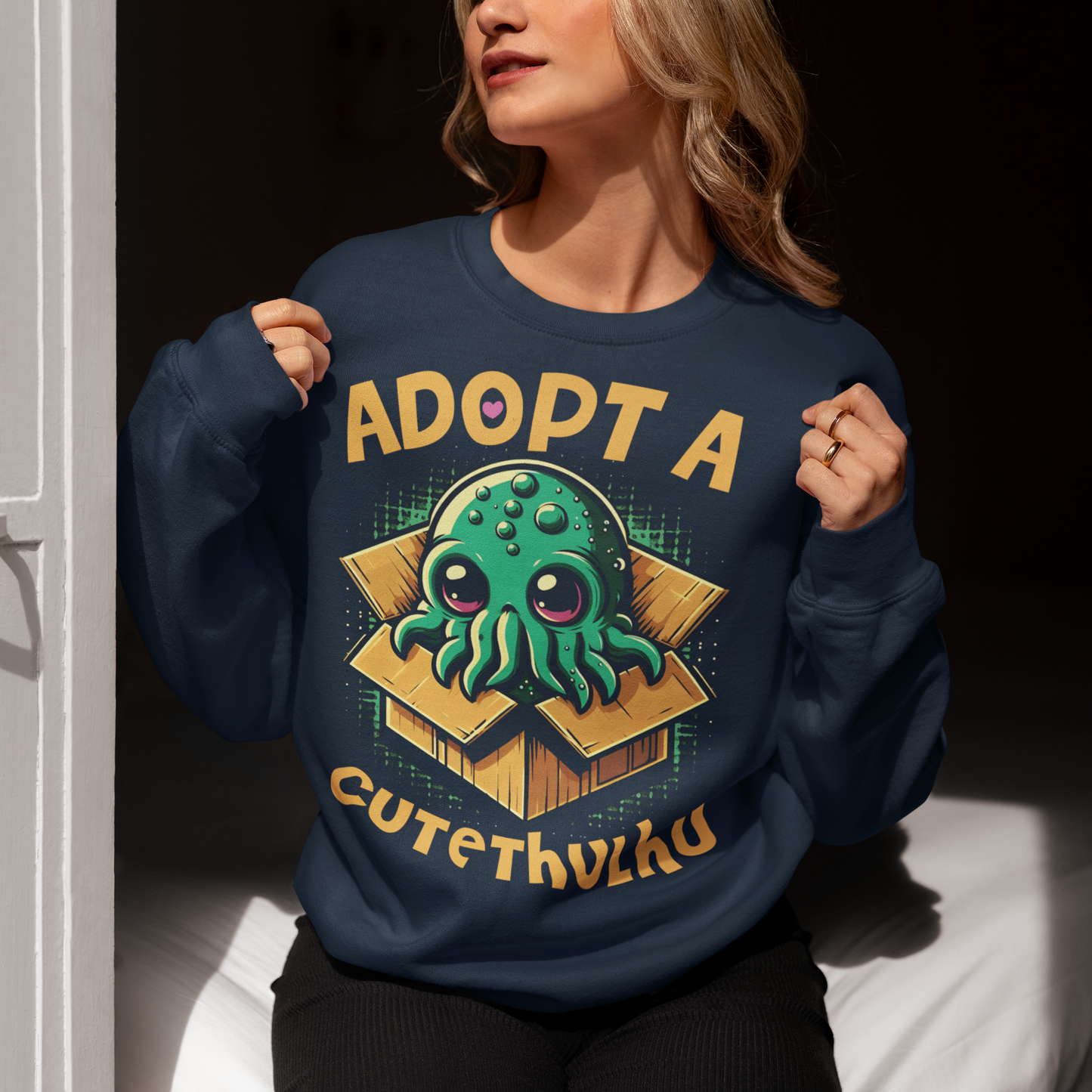 Embrace the whimsy of the cosmic with our "Adopt a Cutethulhu" Sweatshirt! Featuring an adorable depiction of Cthulhu, this charming design reimagines the ancient cosmic entity in the most delightful way possible. Nestled snugly in a cozy cardboard box, our little Cutethulhu waits patiently with big, endearing eyes that are impossible to resist. Whether you're a Lovecraft enthusiast or just a fan of cute and quirky designs, the "Adopt a Cutethulhu" Sweatshirt is the perfect blend of myth and adorableness.