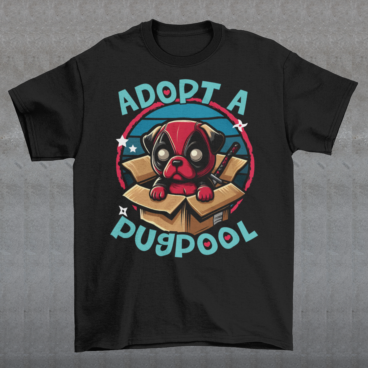 The T-shirt design features an adorable pug dressed as a mercenary, complete with a tiny red and black costume and a mask, sitting comfortably inside a slightly worn cardboard box. Around the design says "ADOPT A PUGPOOL" in a playful, hand-drawn font, giving it a quirky, homemade look.