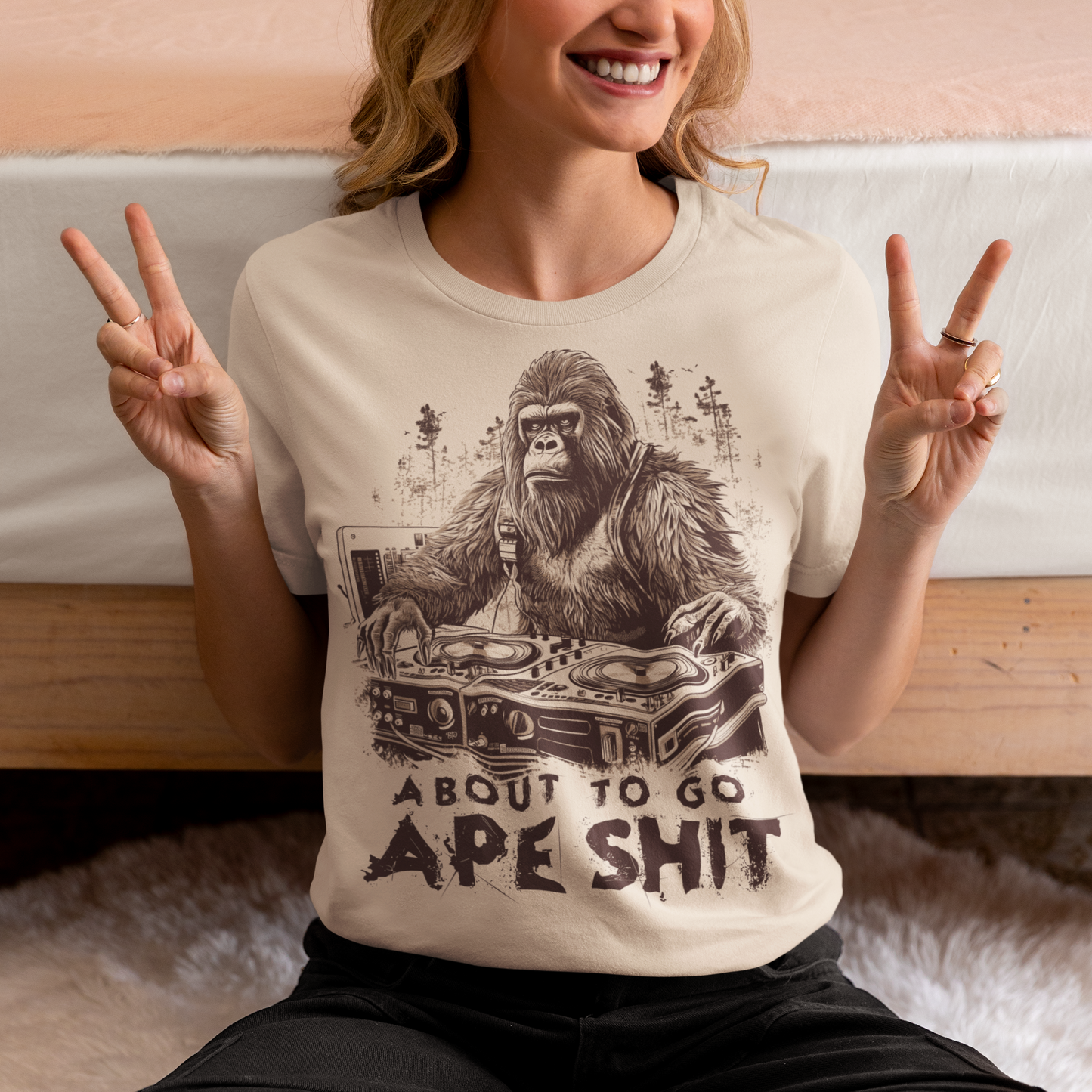 This t-shirt features a bold and eye-catching design of a gorilla playing turntables, surrounded by trees. The gorilla's intense expression and skilled DJing skills convey a sense of energy and excitement. The text "ABOUT TO GO Ape Shit" adds to the playful and humorous tone of the shirt, hinting at the wild and uninhibited fun that the wearer is ready to unleash. This phrase, combined with the gorilla DJ graphic, makes for a unique and memorable design that is sure to stand out in any crowd.