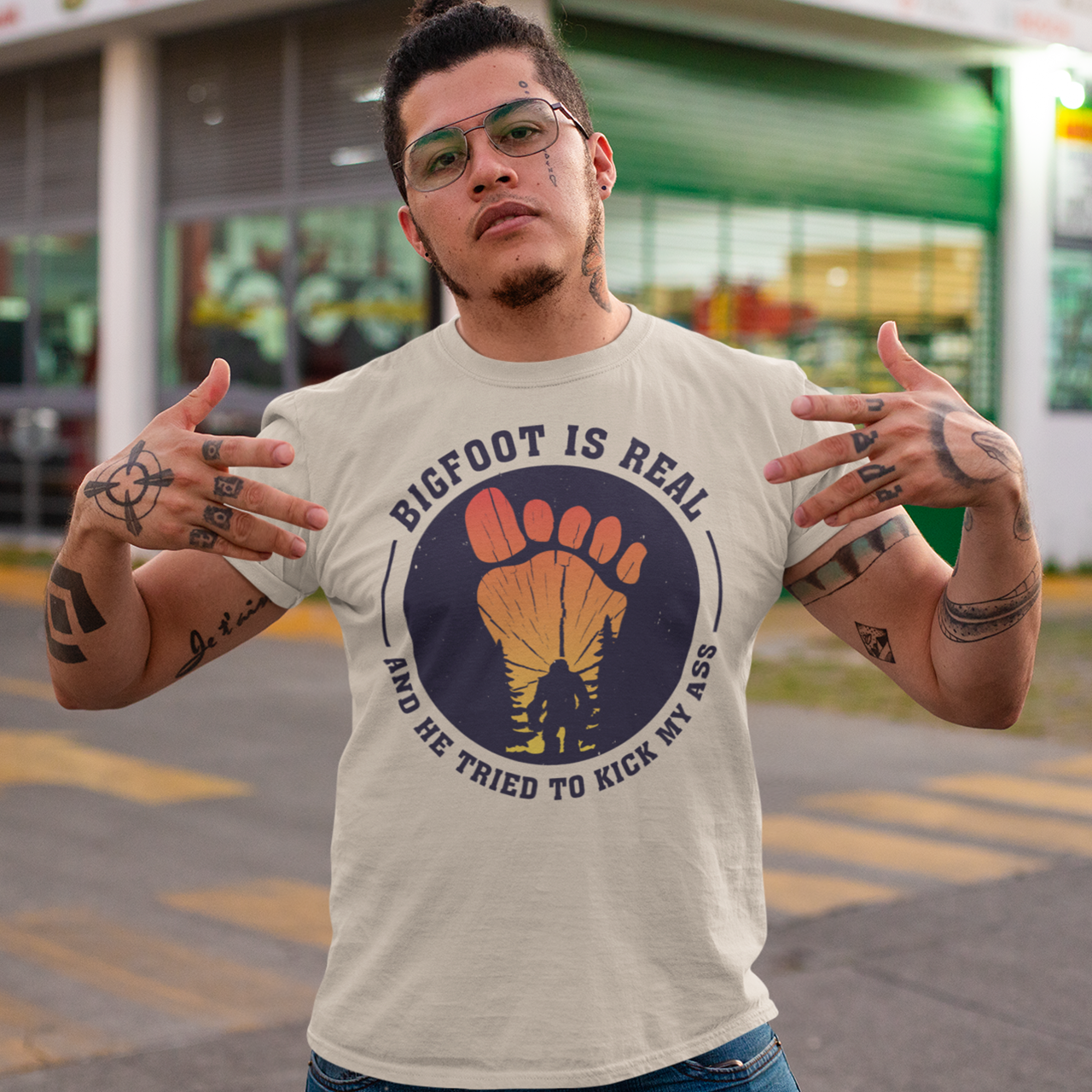 Step into the world of mysterious legends and untamed wilderness with our captivating t-shirt design featuring the legendary creature himself: Bigfoot. Against a breathtaking sunset backdrop, this design encapsulates the thrilling encounter between man and myth. At the center of the design, a striking depiction of Bigfoot takes the spotlight, his towering figure emerging from the dense forest the creature's shaggy fur and muscular frame evoke an air of primal strength and enigma.