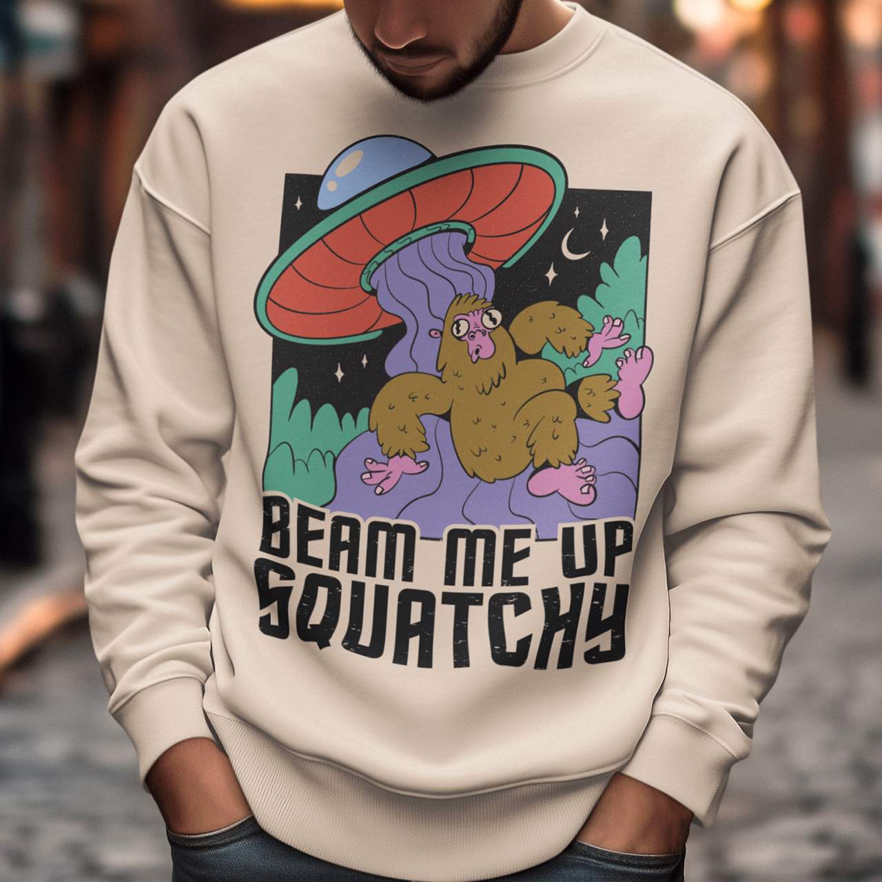 Introducing the extraterrestrial enigma that'll spark conversations and laughter wherever you go – the "BEAM ME UP SQUATCHY" sweatshirt. This whimsical masterpiece seamlessly blends the worlds of cryptozoology and outer space, leaving a trail of intrigue and smiles in its wake. Set against a backdrop of midnight sky, this sweatshirt showcases a captivating scene that defies conventional explanation.