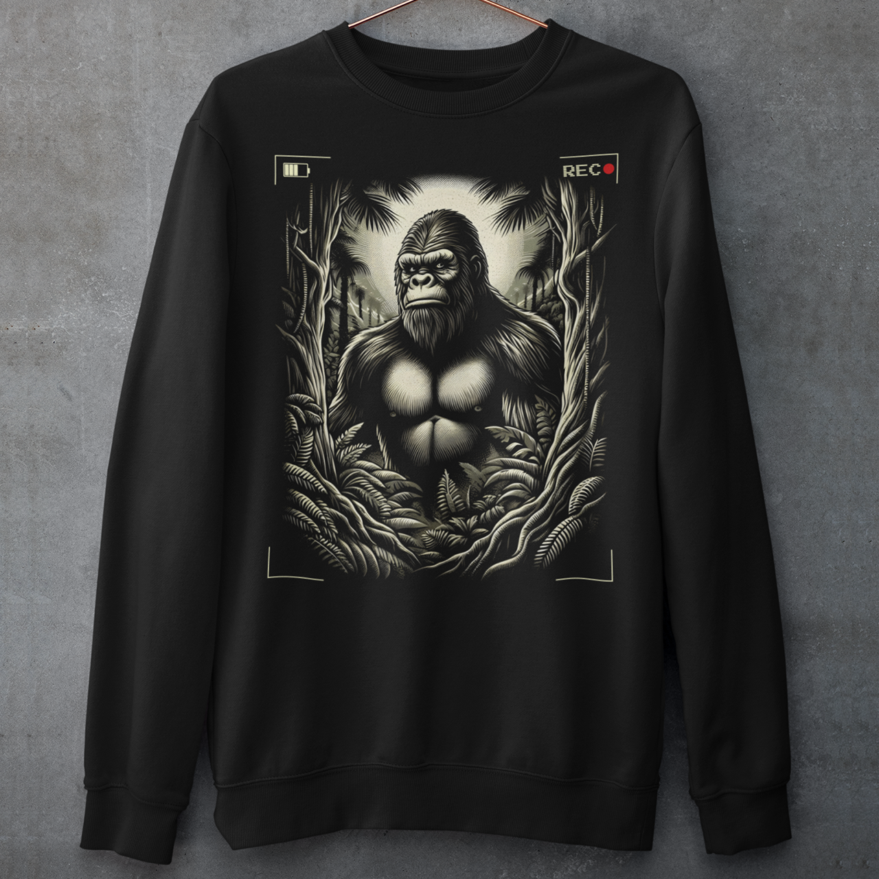 This sweatshirt features a captivating and mysterious scene: Bigfoot, the legendary creature of folklore, is depicted peeking through dense, shadowy trees. The design captures the thrill of a rare sighting with intricate details, from the leaves rustling in the breeze to Bigfoot's curious expression.