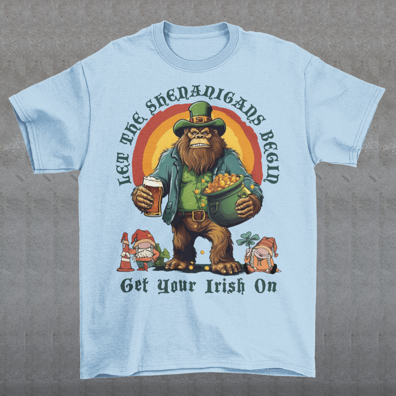 Get ready to celebrate St. Patrick's Day in style with our hilarious and festive Bigfoot-themed t-shirt! This shirt features everyone's favorite cryptid, Bigfoot, dressed in full leprechaun attire, complete with a green hat and shamrock-adorned vest. Bigfoot is depicted holding a frothy beer in one hand and a gleaming pot of gold in the other, ready to join in the festivities. Above this whimsical scene, bold text declares, "LET THE SHENANIGANS BEGIN."