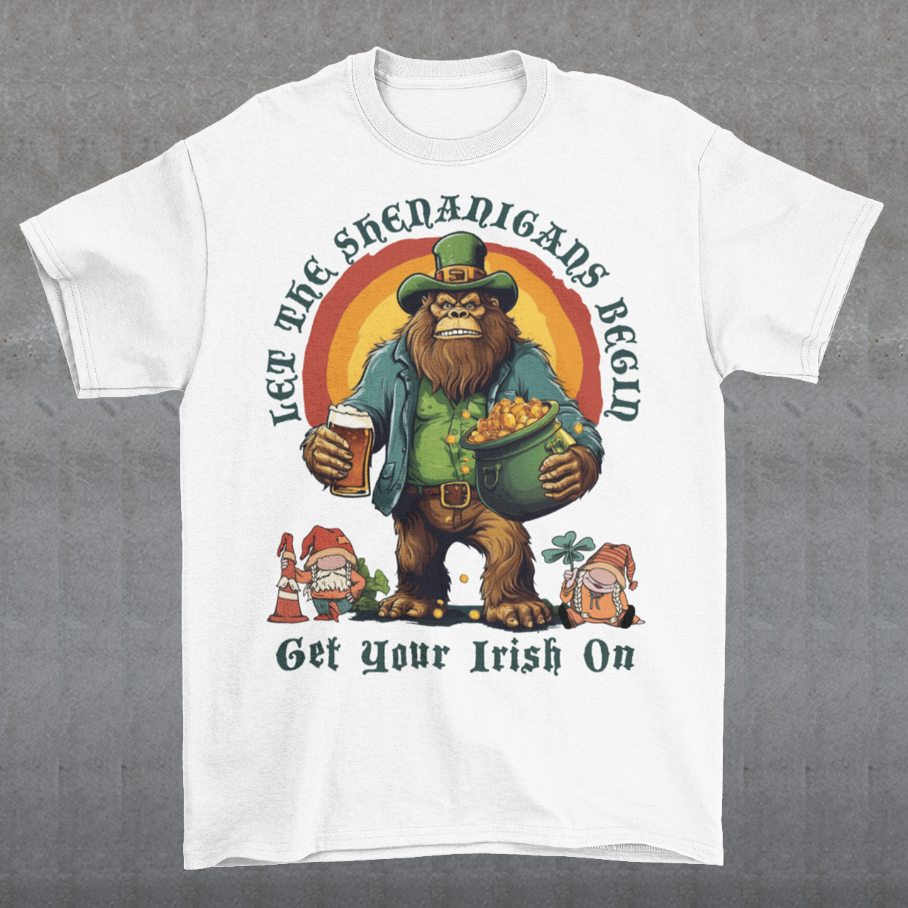 Get ready to celebrate St. Patrick's Day in style with our hilarious and festive Bigfoot-themed t-shirt! This shirt features everyone's favorite cryptid, Bigfoot, dressed in full leprechaun attire, complete with a green hat and shamrock-adorned vest. Bigfoot is depicted holding a frothy beer in one hand and a gleaming pot of gold in the other, ready to join in the festivities. Above this whimsical scene, bold text declares, "LET THE SHENANIGANS BEGIN."