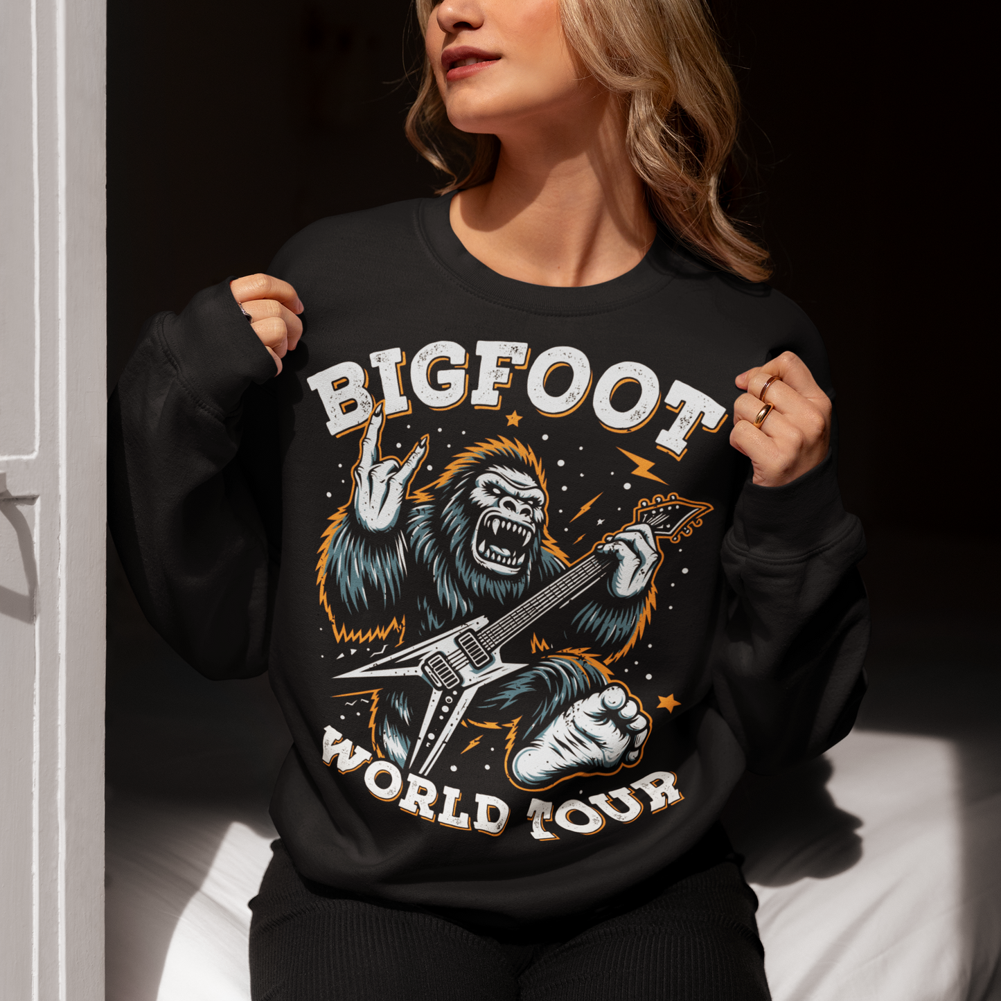 Introducing the ultimate sweatshirt for cryptid enthusiasts and music lovers alike! This vibrant design features the legendary Bigfoot, rocking out on an electric guitar with unparalleled style and energy. Bigfoot, depicted in dynamic detail, stands mid-riff, his shaggy fur flying as he strums the guitar with electrifying intensity. Around this striking image, bold text proudly declares "BIGFOOT WORLD TOUR."