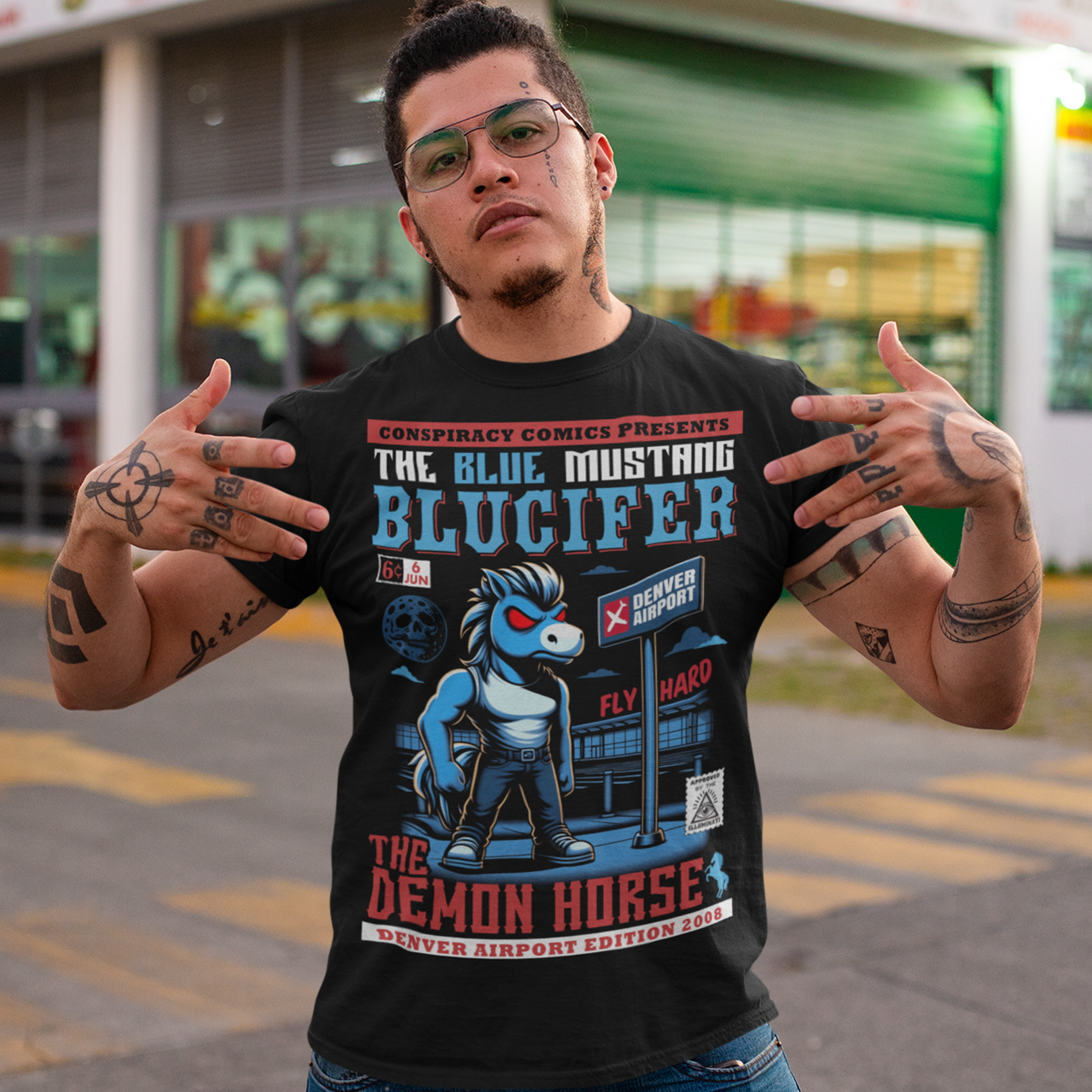Unleash the legend with this bold t-shirt featuring Blucifer, the infamous blue mustang brought to life in a striking comic book design! This vibrant illustration showcases the menacing yet captivating spirit of Blucifer, complete with glowing red eyes and dynamic comic-style shading. The design is set against a dramatic backdrop of Denver Airport emphasizing Blucifer's larger-than-life presence. Perfect for fans of myth, art, and Denver’s most iconic (and controversial) sculpture.