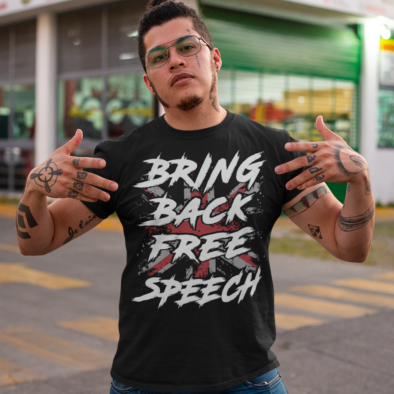 Make a bold statement with our "BRING BACK FREE SPEECH" t-shirt, featuring the iconic British flag as a backdrop to a powerful message. This design fuses patriotism with a call to action, standing up for one of the most fundamental democratic rights — freedom of expression.