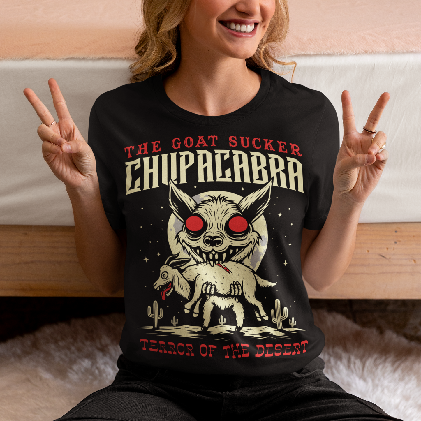 Introducing the ultimate homage to folklore and mystery – "The Goat Sucker Chupacabra" T-shirt! Step into the realm of the unknown with this captivating design depicting the infamous chupacabra in action. Against the backdrop of a barren desert, the chupacabra is depicted in all its eerie glory, locked in its iconic pose of sucking the life force from a hapless goat. Above the striking imagery, bold text proudly proclaims "THE GOAT SUCKER CHUPACABRA" ensuring that the wearer embodies the legend.