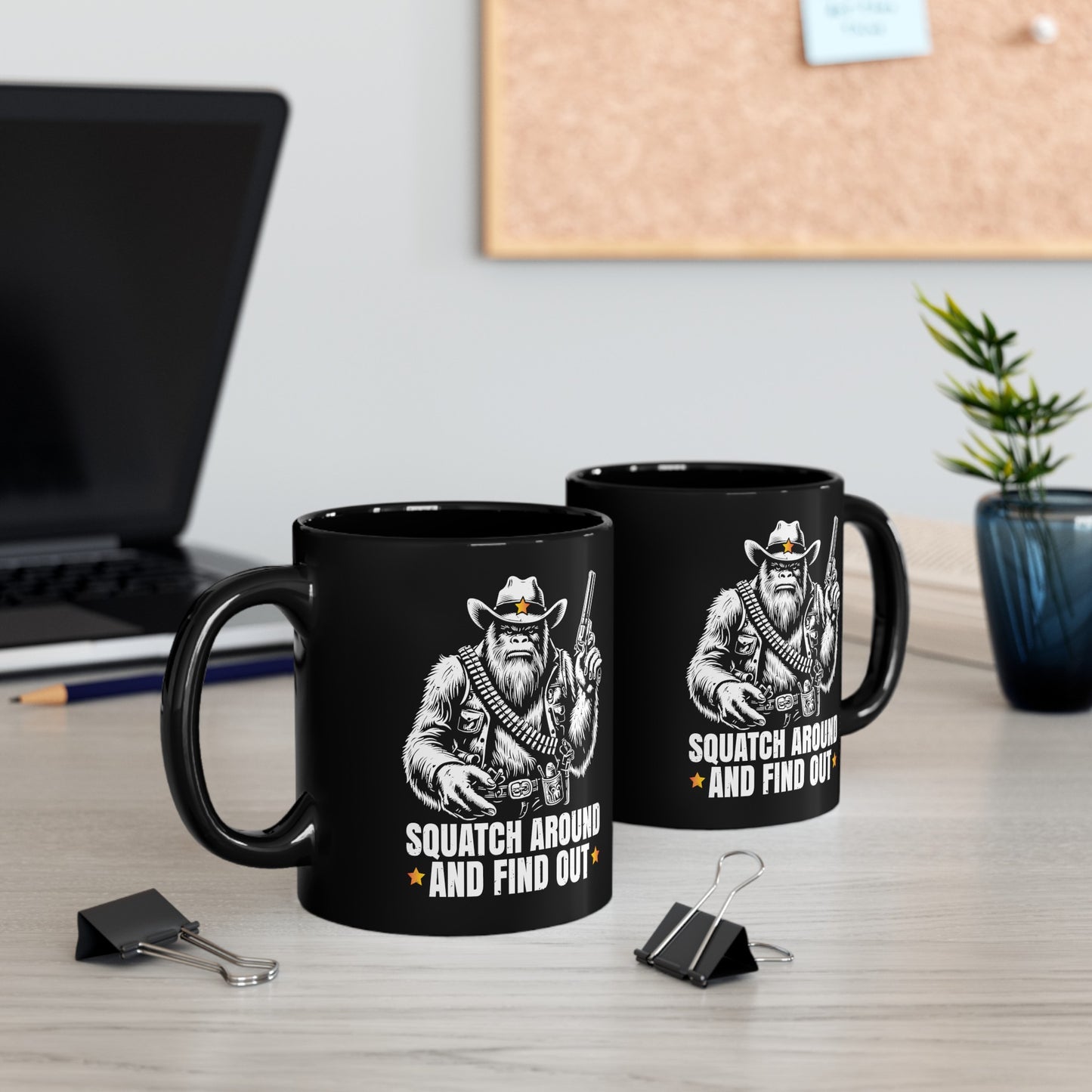 Black mug of a sheriff Sasquatch in the wild west holding a gun with text underneath SQUATCH AROUND AND FIND OUT.