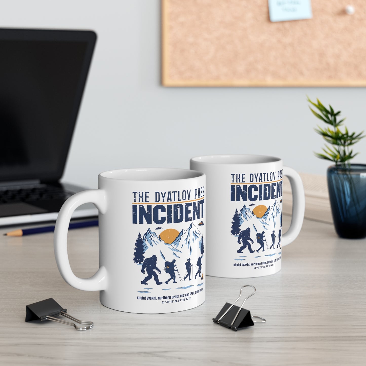White mug of 3 hikers including Bigfoot in snowy mountains with UFOs and text THE DYATLOV PASS INCIDENT.