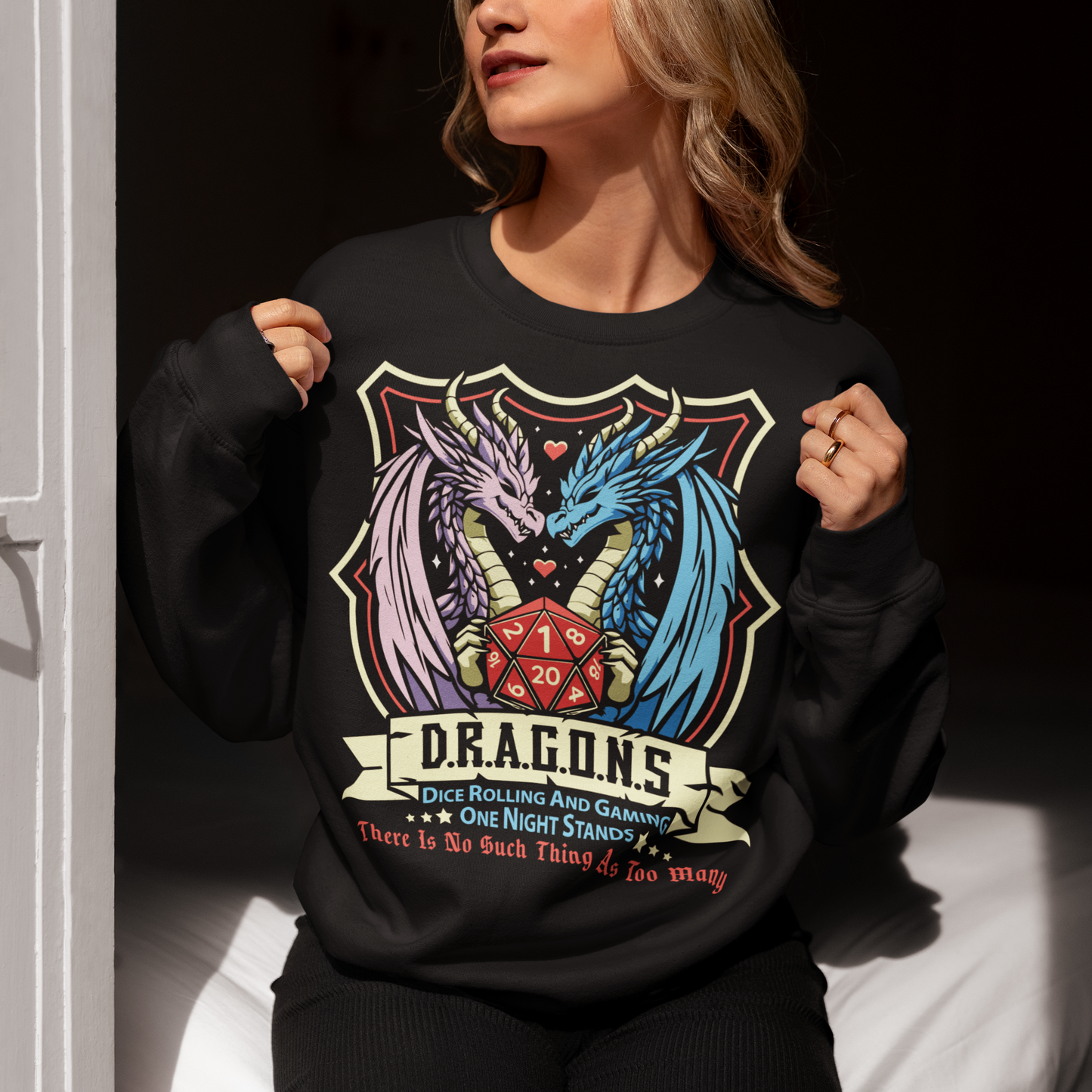 Embrace your inner adventurer with this bold and witty D.R.A.G.O.N.S. Shield Emblem Sweatshirt. At the heart of the design is a powerful crest-style shield, flanked by a fierce male and female dragon, symbolizing strength, balance, and epic storytelling. Centered within the shield is a classic RPG dice, gleaming with gamer pride. Perfect for tabletop warriors, RPG fans, and those who roll for both initiative and fun.