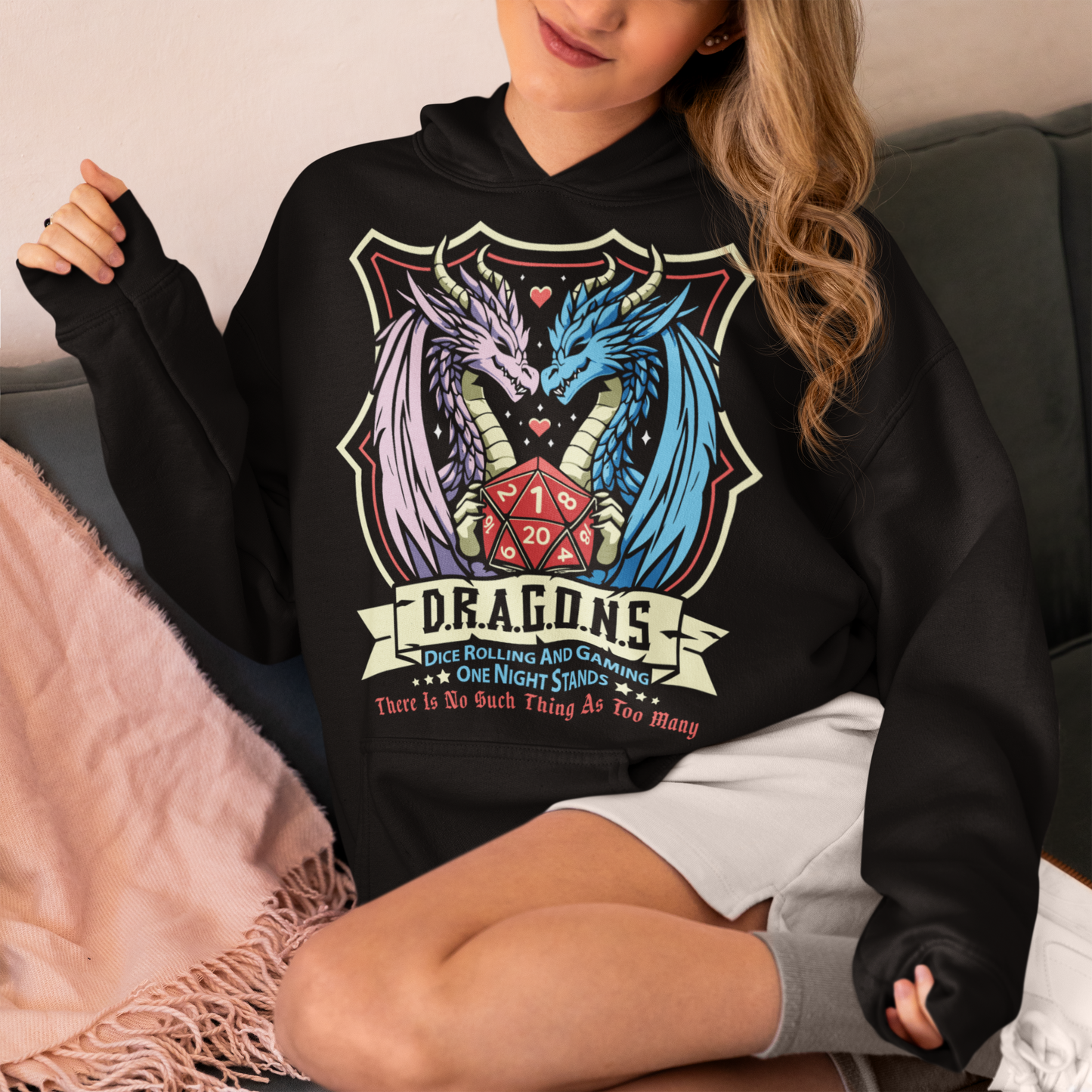 Embrace your inner adventurer with this bold and witty D.R.A.G.O.N.S. Shield Emblem Hoodie. At the heart of the design is a powerful crest-style shield, flanked by a fierce male and female dragon, symbolizing strength, balance, and epic storytelling. Centered within the shield is a classic RPG dice, gleaming with gamer pride. Perfect for tabletop warriors, RPG fans, and those who roll for both initiative and fun.
