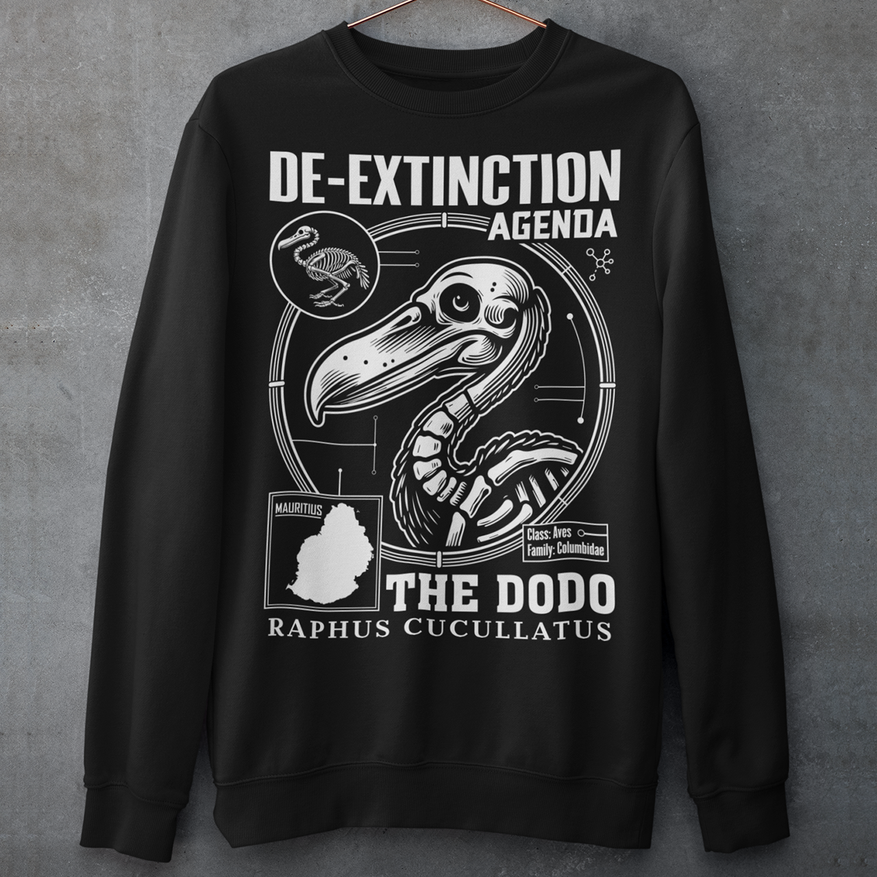 A graphic sweatshirt featuring a stylized illustration of a dodo bird, standing upright with a proud, almost defiant expression. The dodo is depicted in vibrant colors, blending realism with a slightly cartoonish flair. Above the bird, bold, capitalized text reads "DE-EXTINCTION AGENDA" in a futuristic font, suggesting a science fiction or activist tone. The design evokes themes of genetic engineering, conservation, and the revival of extinct species. The shirt is a statement piece with humor.