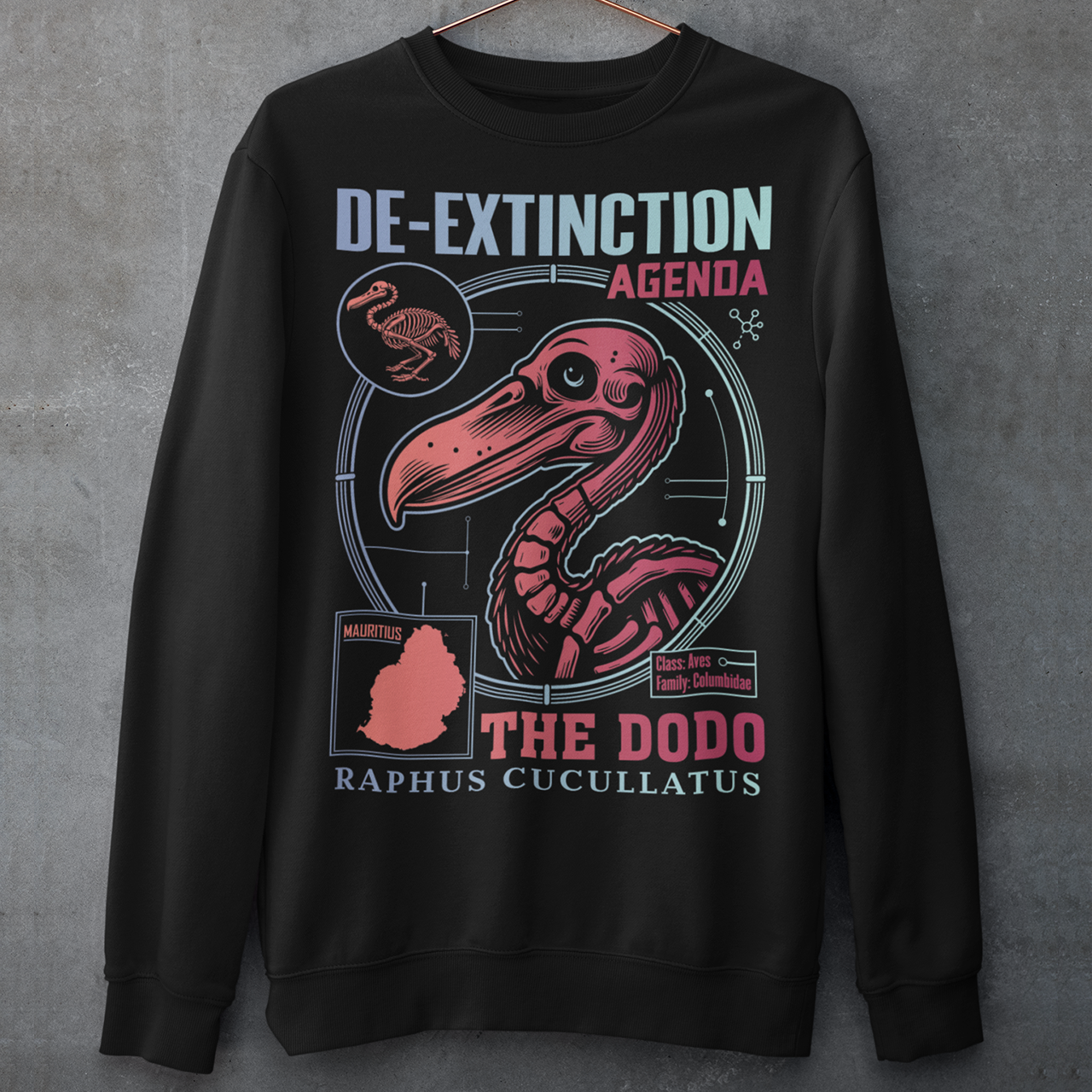 A graphic sweatshirt featuring a stylized illustration of a dodo bird, standing upright with a proud, almost defiant expression. The dodo is depicted in vibrant colors, blending realism with a slightly cartoonish flair. Above the bird, bold, capitalized text reads "DE-EXTINCTION AGENDA" in a futuristic font, suggesting a science fiction or activist tone. The design evokes themes of genetic engineering, conservation, and the revival of extinct species. The shirt is a statement piece with humor.