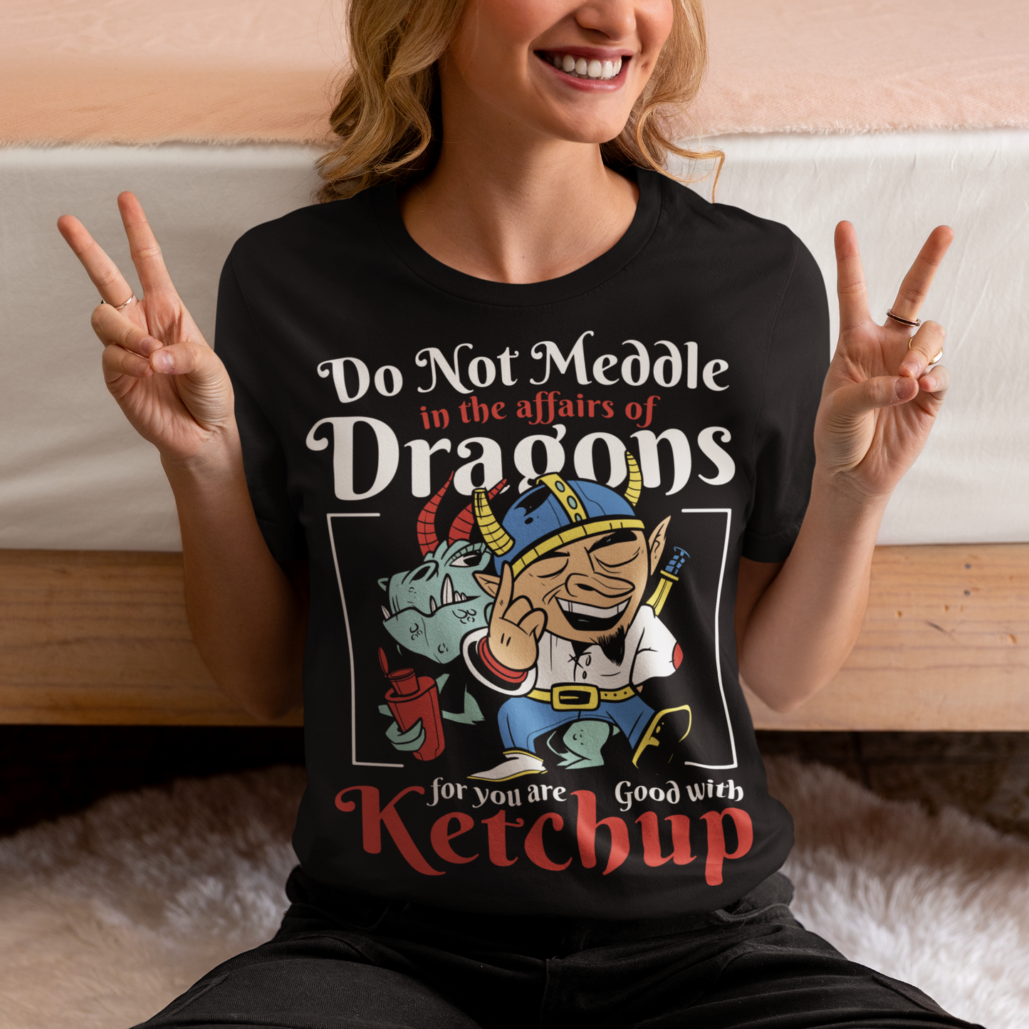 Introducing our whimsically fierce and flavorful "Dragon Connoisseur" T-shirt! This eye-catching design features a majestic dragon with a mischievous grin, proudly holding a bottle of ketchup, standing ominously behind a brave Viking. The caption, "DO NOT MEDDLE IN THE AFFAIRS OF DRAGONS FOR YOU ARE GOOD WITH KETCHUP," adds a touch of humor and a warning to all who dare to challenge the fiery and saucy taste preferences of these mythical creatures.