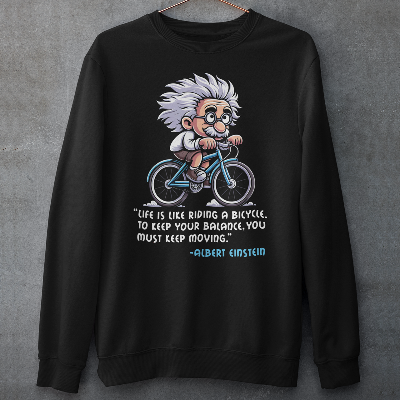 Discover the perfect blend of intellect and inspiration with our "Einstein Cycling" Sweatshirt. This unique design features the legendary physicist Albert Einstein enjoying a leisurely bike ride, embodying both his playful spirit and his profound wisdom. Below the whimsical illustration, you'll find one of Einstein's most motivational quotes: "Life is like riding a bicycle. To keep your balance, you must keep moving."