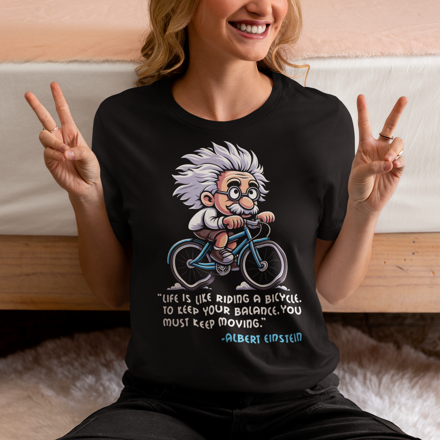 Discover the perfect blend of intellect and inspiration with our "Einstein Cycling" T-shirt. This unique design features the legendary physicist Albert Einstein enjoying a leisurely bike ride, embodying both his playful spirit and his profound wisdom. Below the whimsical illustration, you'll find one of Einstein's most motivational quotes: "Life is like riding a bicycle. To keep your balance, you must keep moving."