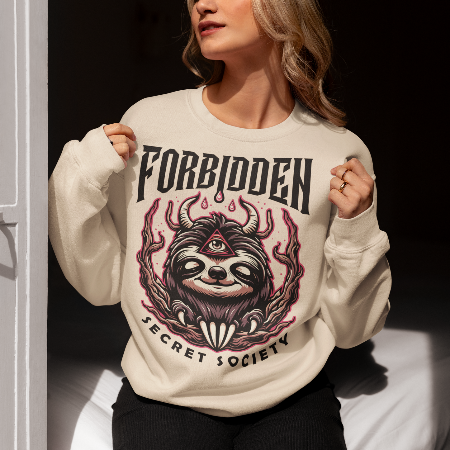 "Step into the enigmatic world of clandestine societies with our Forbidden Secret Society sweatshirt featuring the elusive Illuminati sloth. This captivating design showcases a sloth adorned with symbolic imagery, including the all-seeing third eye, hinting at hidden knowledge and mystic insight. Embrace the intrigue and mystery as you don this unique sweatshirt, inviting curiosity and speculation wherever you go.