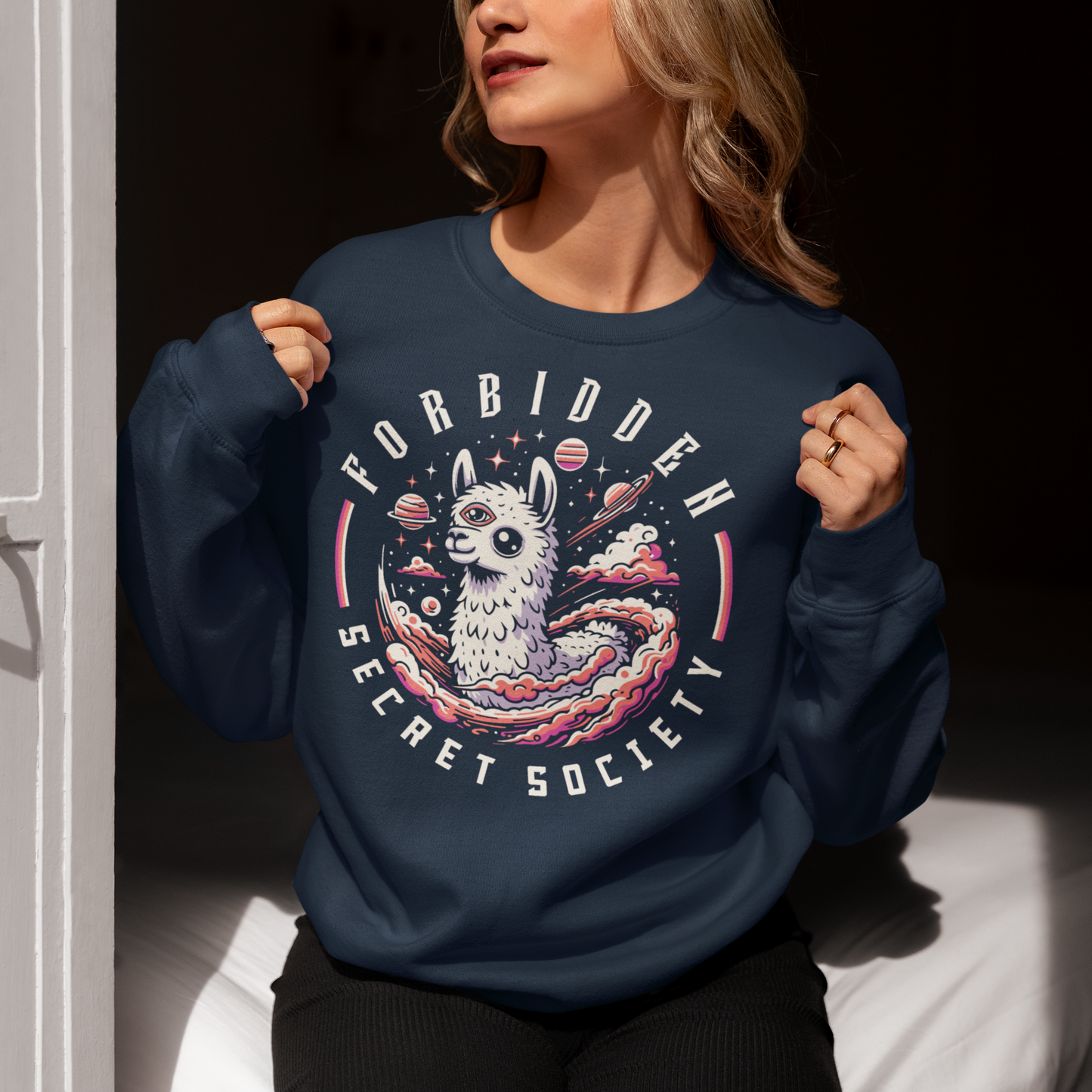 "Step into the enigmatic world of clandestine societies with our Forbidden Secret Society sweatshirt featuring the elusive Illuminati Llama. This captivating design showcases a llama adorned with symbolic imagery, including the all-seeing third eye, hinting at hidden knowledge and mystic insight. Embrace the intrigue and mystery as you don this unique sweatshirt, inviting curiosity and speculation wherever you go.