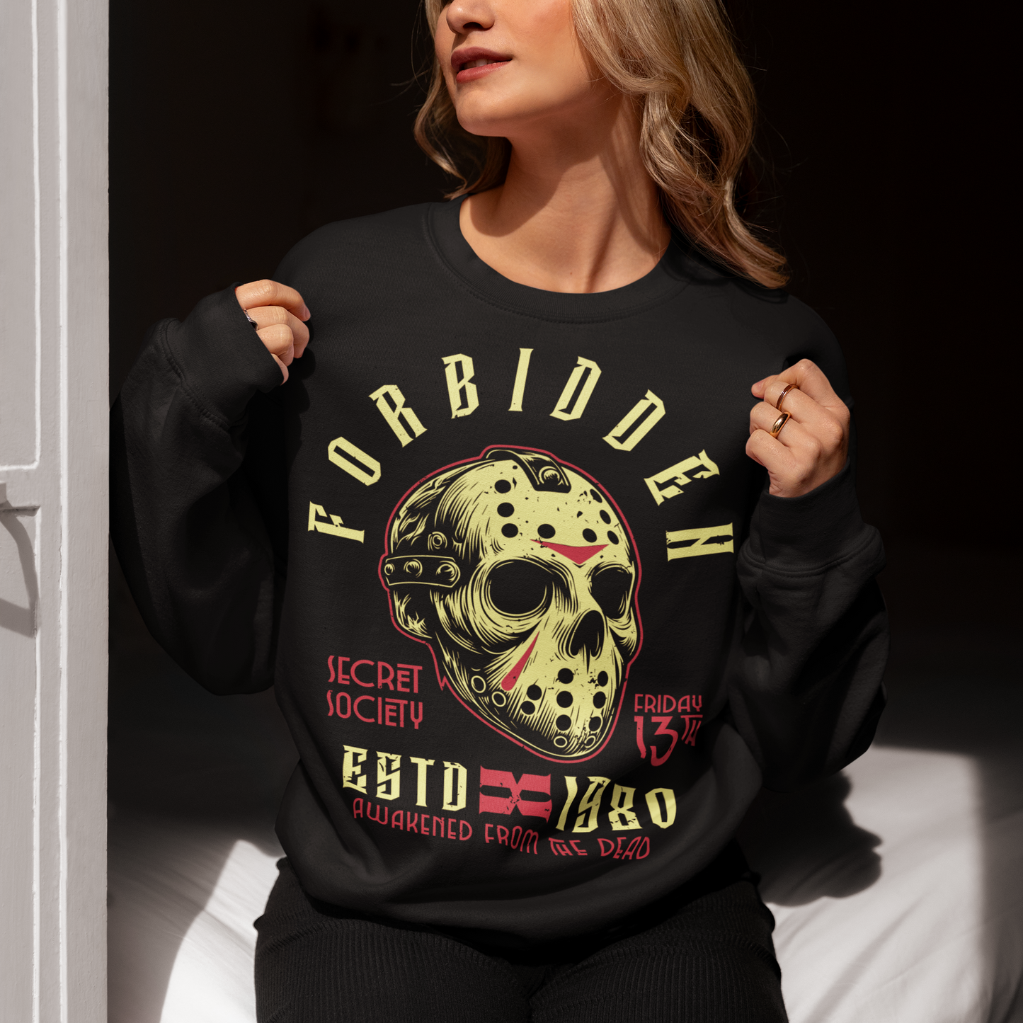 Black sweatshirt of a horror hockey mask and text "FORBIDDEN SECRET SOCIETY AWAKENED FROM THE DEAD."