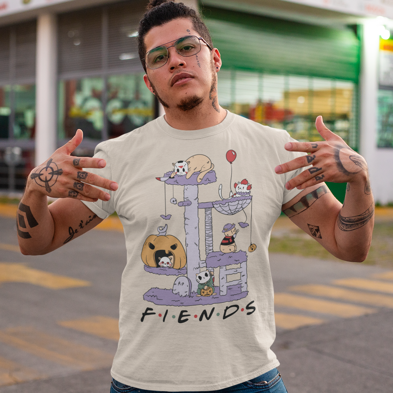 Cream halloween t-shirt of horror cat characters on a cat tree with text "FIENDS".