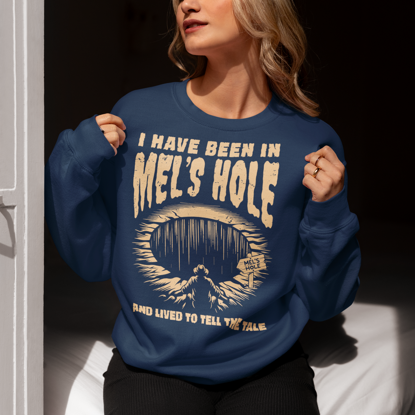 Step into the strange with this quirky and mysterious shirt! Featuring a bold illustration of a curious man peering into a dark, bottomless abyss, this shirt pays homage to the legendary paranormal tale of Mel's Hole — a supposed infinite pit in the wilds of Washington State. The vintage-style artwork is topped with the eerie invitation: "VISIT MEL'S HOLE" in retro tourism font, blending humor, folklore, and a dash of the unexplained.