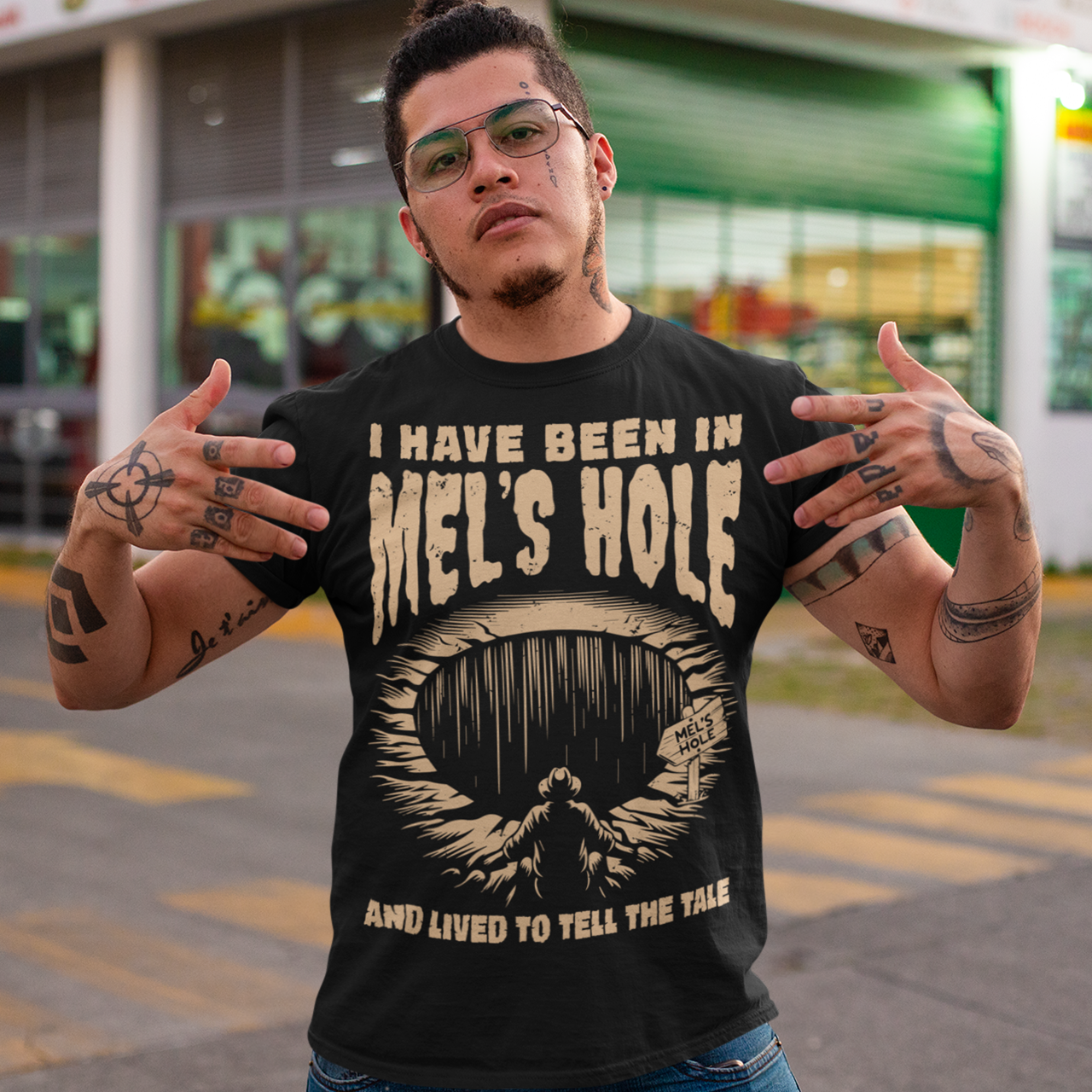 Step into the strange with this quirky and mysterious tee! Featuring a bold illustration of a curious man peering into a dark, bottomless abyss, this shirt pays homage to the legendary paranormal tale of Mel's Hole — a supposed infinite pit in the wilds of Washington State. The vintage-style artwork is topped with the eerie invitation: "VISIT MEL'S HOLE" in retro tourism font, blending humor, folklore, and a dash of the unexplained.