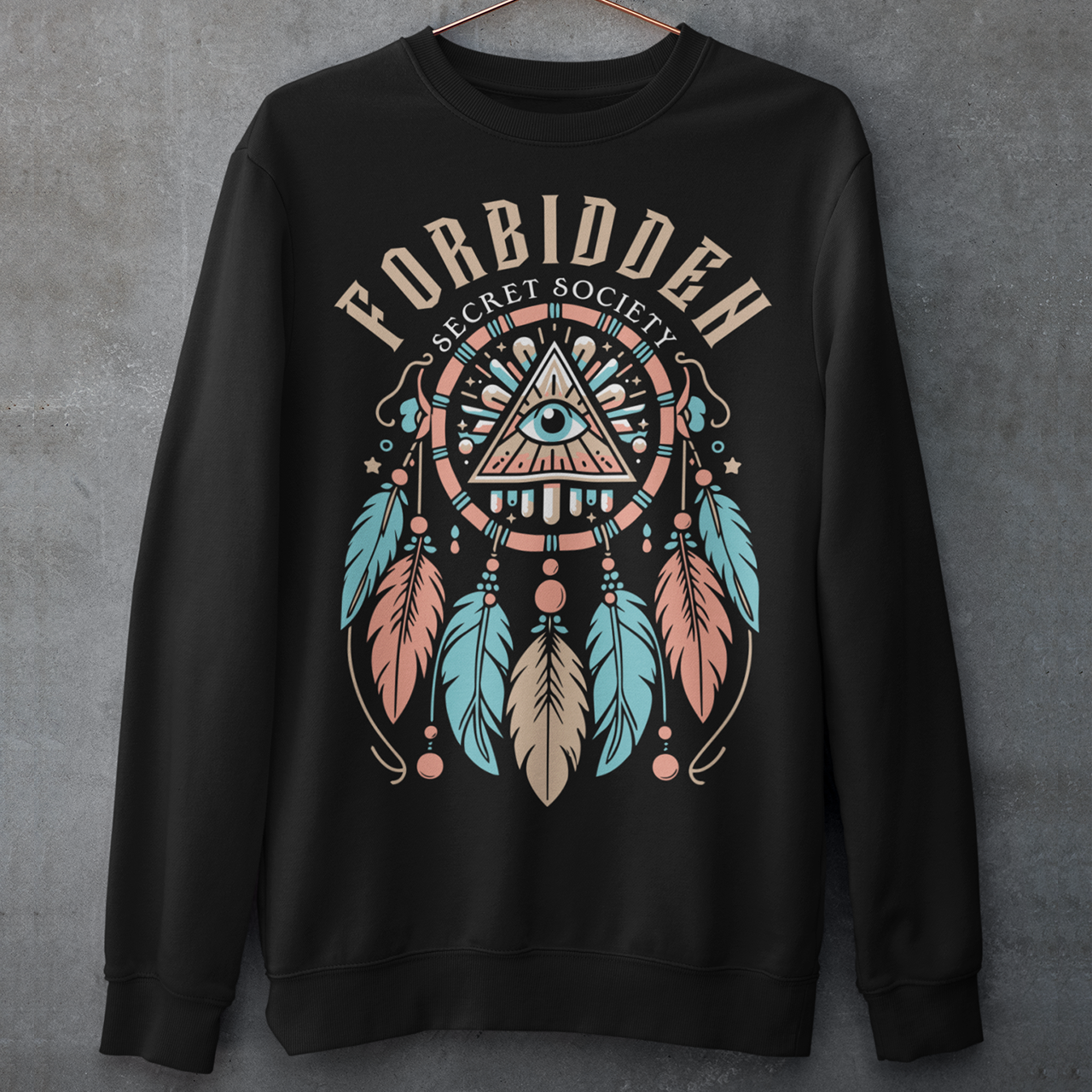 "Step into the enigmatic world of clandestine knowledge with our Illuminati Dreamcatcher sweatshirt. Featuring an intricate design that merges the mystique of the Illuminati symbol with the cultural heritage of dreamcatchers, this tee is a fusion of intrigue and symbolism. The central eye, a hallmark of Illuminati iconography, peers out from the heart of the dreamcatcher, symbolizing the pursuit of hidden truths and enlightenment.