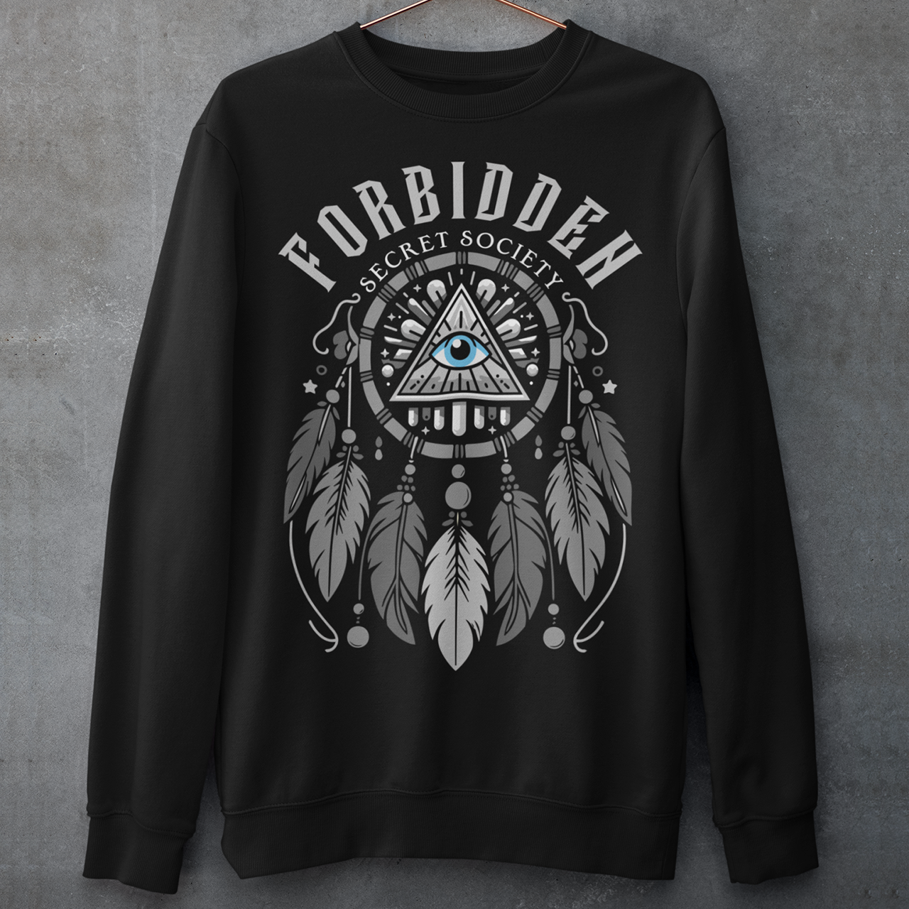 "Step into the enigmatic world of clandestine knowledge with our Illuminati Dreamcatcher sweatshirt. Featuring an intricate design that merges the mystique of the Illuminati symbol with the cultural heritage of dreamcatchers, this tee is a fusion of intrigue and symbolism. The central eye, a hallmark of Illuminati iconography, peers out from the heart of the dreamcatcher, symbolizing the pursuit of hidden truths and enlightenment.