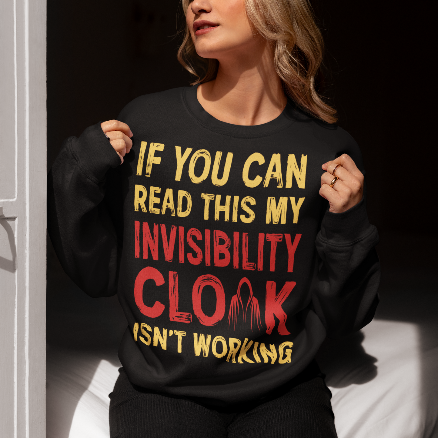 Turn heads and raise a few laughs with this clever and quirky sweatshirt! Featuring the bold text “IF YOU CAN READ THIS MY INVISIBILITY CLOAK ISN'T WORKING”, this shirt is perfect for wizards, pranksters, and introverts alike. Whether you're a fan of fantasy, sarcasm, or just enjoy flying under the radar, this shirt delivers a magical dose of humor.