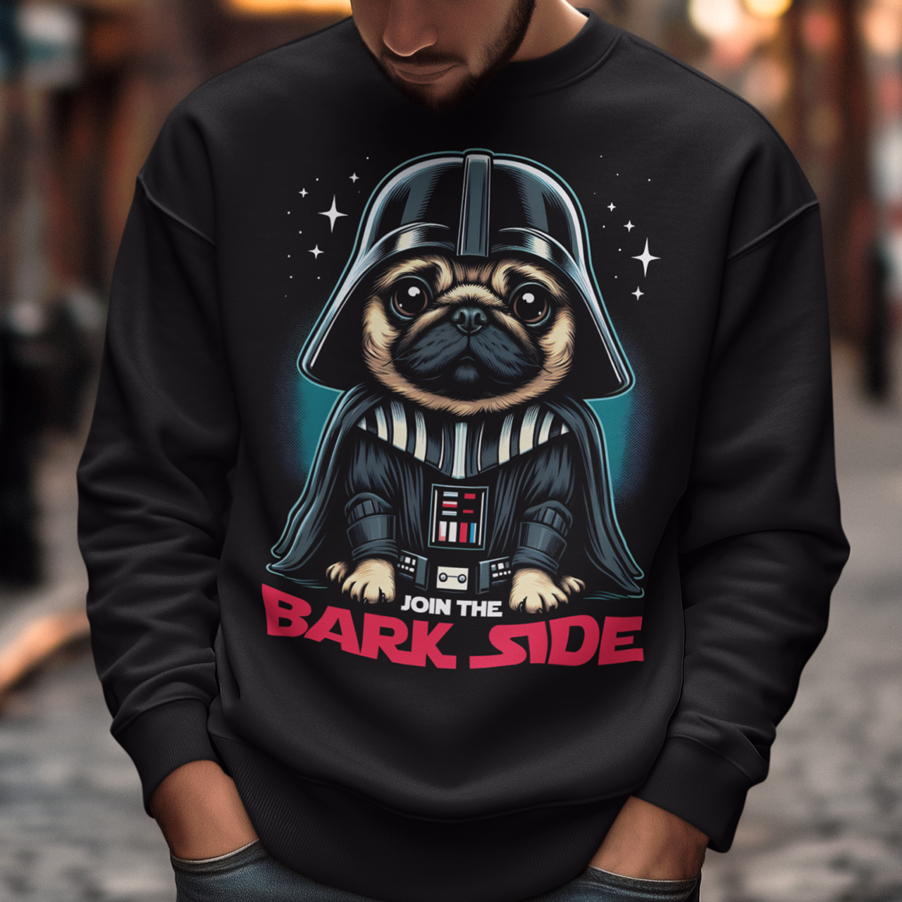 Introducing the ultimate "Join the Bark Side" Sweatshirt. This playful design features an adorable pug dressed as a Sith Lord and a determined, yet undeniably cute, expression. The pug's wrinkled face and intense stare will make anyone smile, as he embodies the dark side in the most charming way possible. Beneath the pug, bold text reads "JOIN THE BARK SIDE," adding a humorous twist to the classic phrase. This shirt is sure to be a hit for those with a love for pups and galactic adventures!