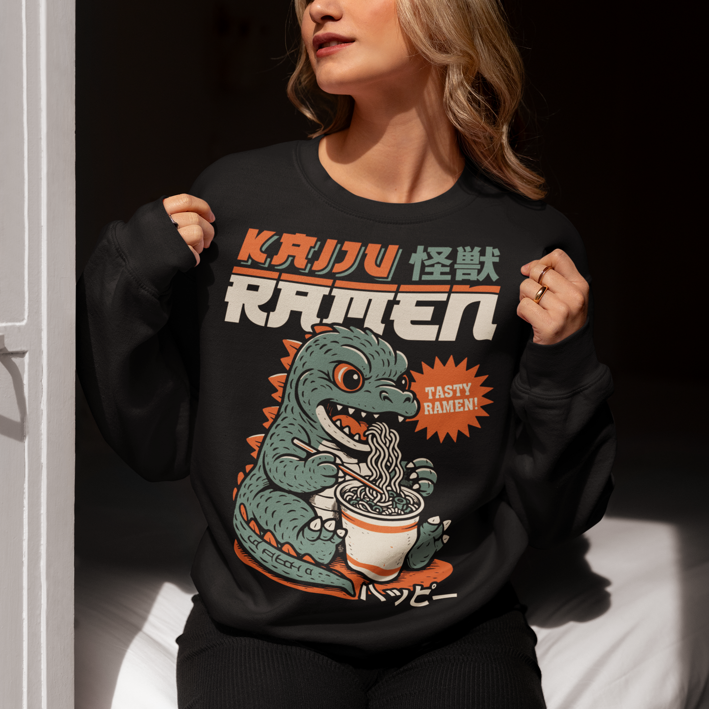 This epic sweatshirt features a towering Japanese monster (Kaiju) mid-slurp, devouring a massive bowl of ramen with wild abandon. With chopsticks in claw and noodles flying, it’s the ultimate mashup of monstrous hunger and culinary chaos. Bold text above reads KAIJU RAMEN, bringing Tokyo street-style energy to your wardrobe.
