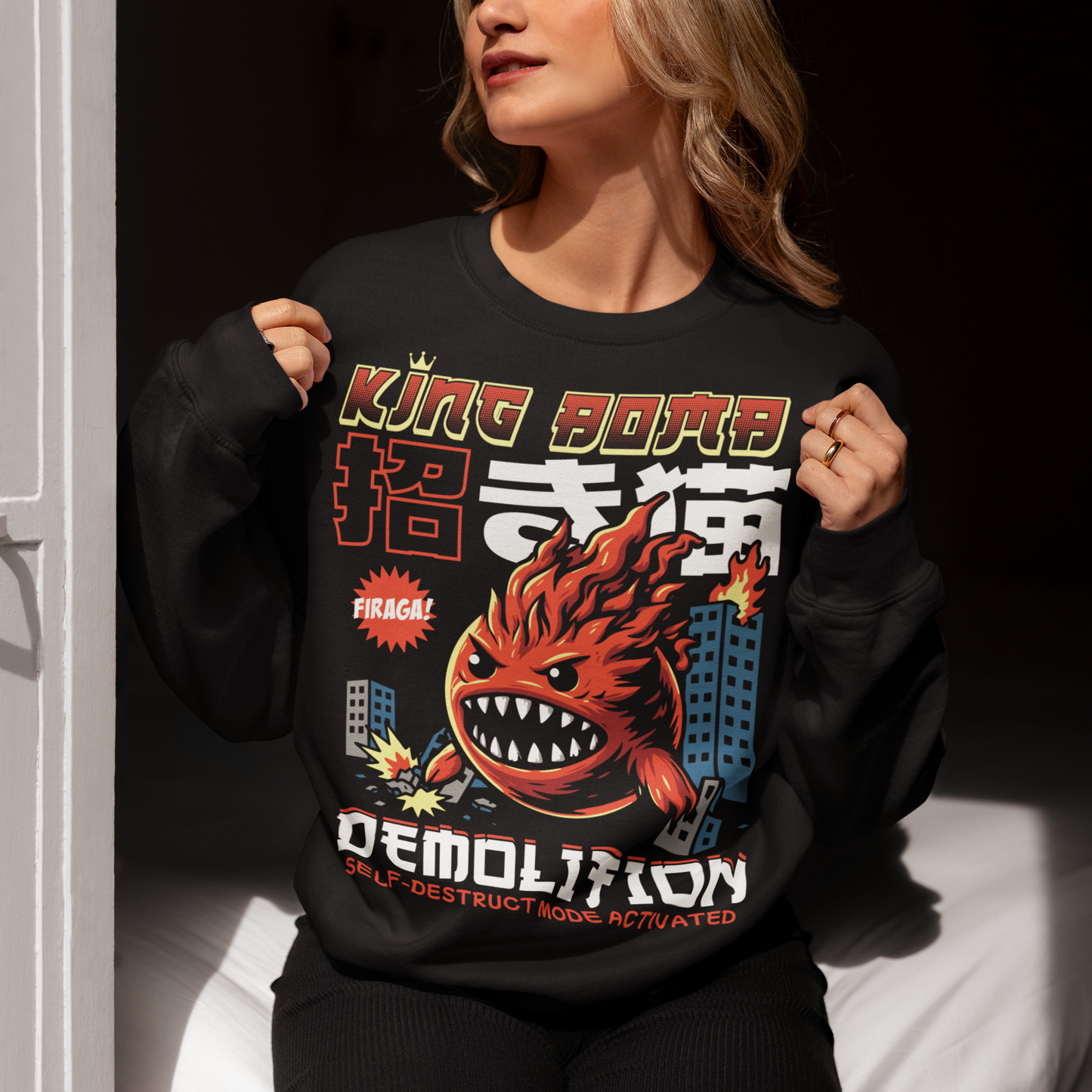 Unleash the chaos with our Japanese-style “King Bomb Demolition” Sweatshirt. Featuring a larger-than-life kaiju-inspired character, King Bomb towers over a crumbling cityscape in a striking manga/anime art style. Explosive details capture the raw energy of destruction as skyscrapers topple in his wake. Bold Japanese design elements bring an authentic streetwear vibe, while the text “KING BOMB DEMOLITION” adds a gritty punch to the artwork.