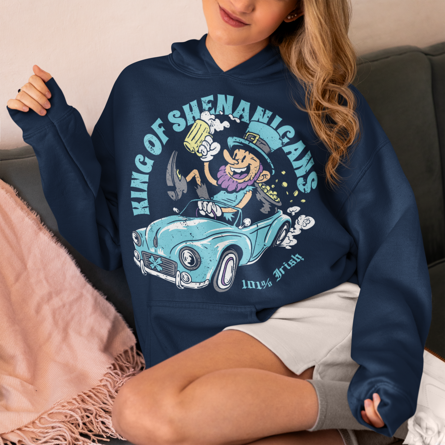 Get ready to stir up some trouble with this hilarious hoodie featuring a leprechaun enjoying a cold pint of beer in the front seat of a car! With his mischievous grin and twinkling eyes, this little guy is clearly the king of shenanigans.