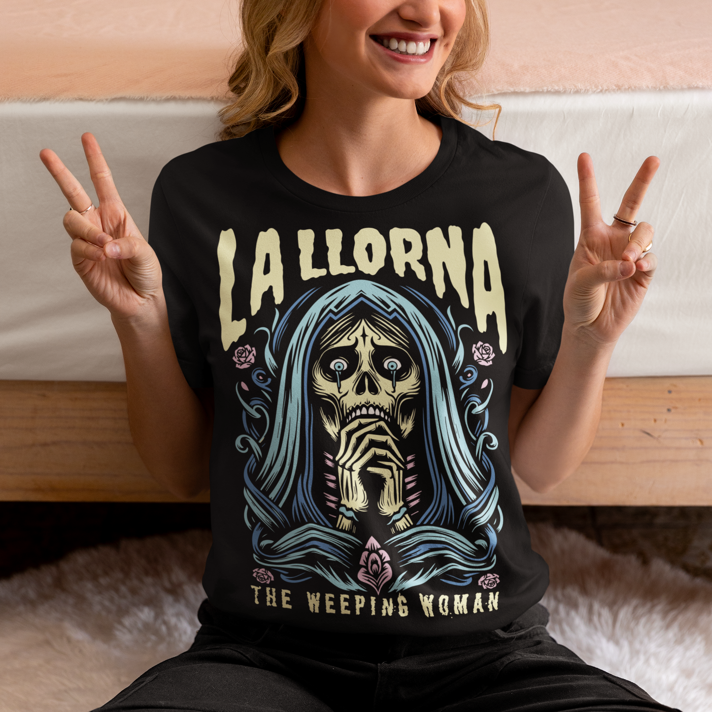 This striking La Llorona t-shirt features a haunting depiction of the legendary Weeping Woman, her ghostly figure shrouded in mist, with flowing hair and a sorrowful expression as she searches for her lost children. The design captures the eerie, chilling essence of the famous Latin American folktale, blending dark, gothic tones with an ethereal glow. Above the image, bold lettering reads "LA LLORONA", while below, the translation "THE WEEPING WOMAN" adds to the eerie mystique.