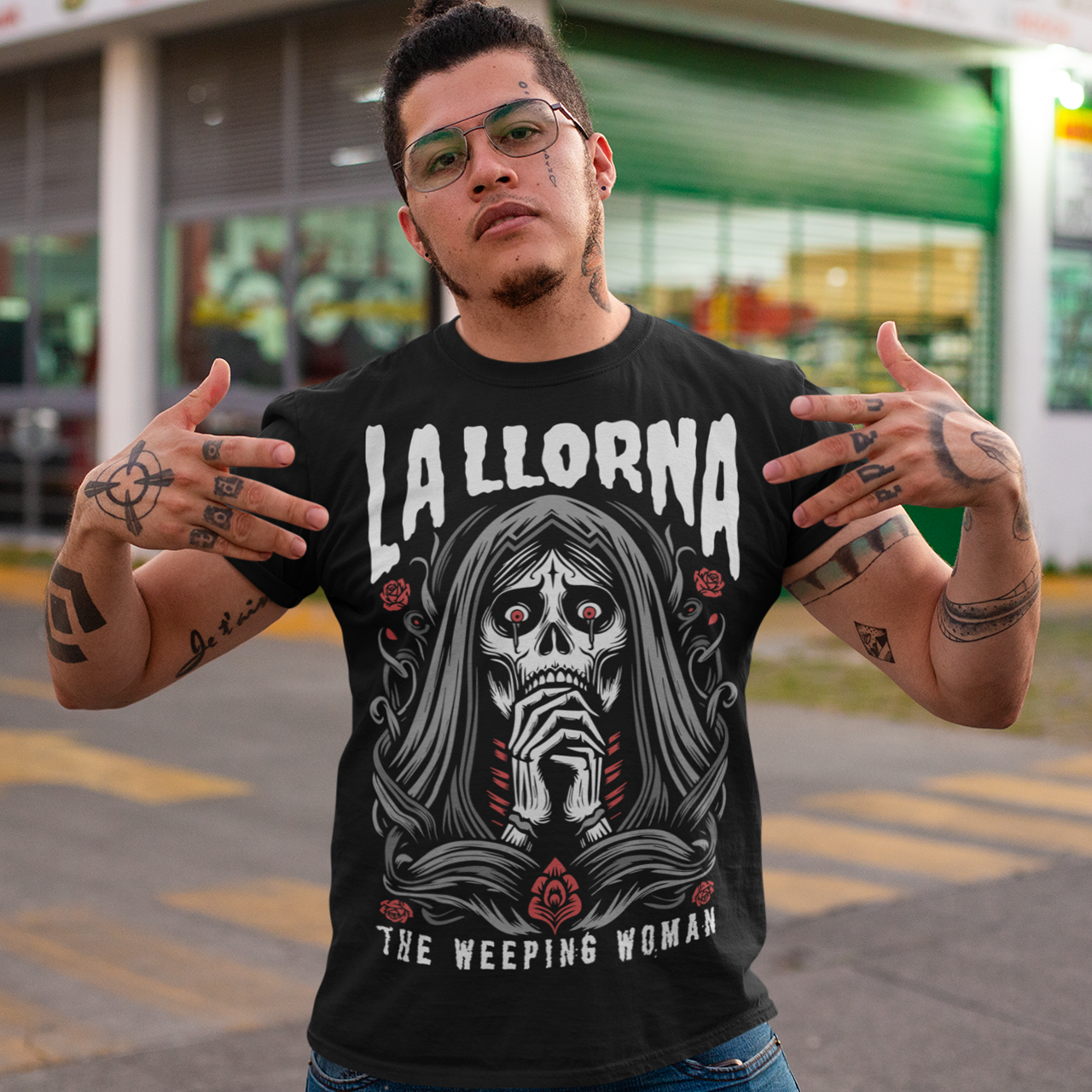 This striking La Llorona t-shirt features a haunting depiction of the legendary Weeping Woman, her ghostly figure shrouded in mist, with flowing hair and a sorrowful expression as she searches for her lost children. The design captures the eerie, chilling essence of the famous Latin American folktale, blending dark, gothic tones with an ethereal glow. Above the image, bold lettering reads "LA LLORONA", while below, the translation "THE WEEPING WOMAN" adds to the eerie mystique. Perfect for fans of folklore