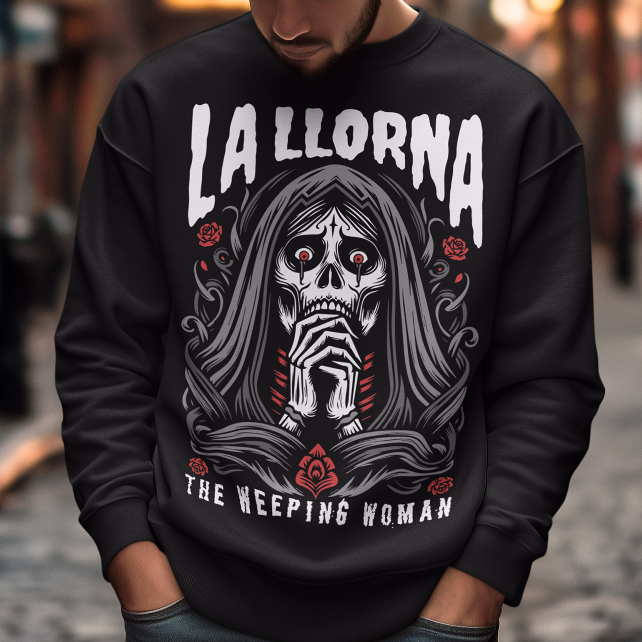 This striking La Llorona sweatshirt features a haunting depiction of the legendary Weeping Woman, her ghostly figure shrouded in mist, with flowing hair and a sorrowful expression as she searches for her lost children. The design captures the eerie, chilling essence of the famous Latin American folktale, blending dark, gothic tones with an ethereal glow. Above the image, bold lettering reads "LA LLORONA", while below, the translation "THE WEEPING WOMAN" adds to the eerie mystique.