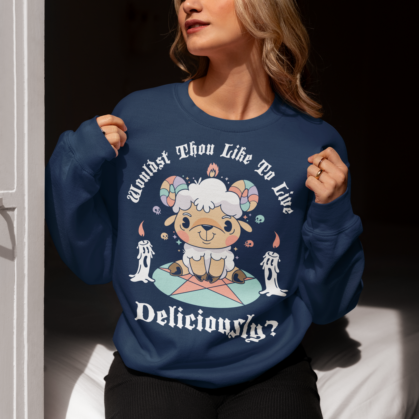 Unleash your inner rebel with this striking graphic sweatshirt featuring a smug, mystical goat perched atop a pentagram—summoning vibes as bold as your wardrobe. Inspired by folklore and a hint of witchy sarcasm, the chilling phrase "WOULDST THOU LIKE TO LIVE DELICIOUSLY?" is scrawled across the design in eerie, arcane lettering. Perfect for fans of the occult, dark humor, and aesthetic rebellion.