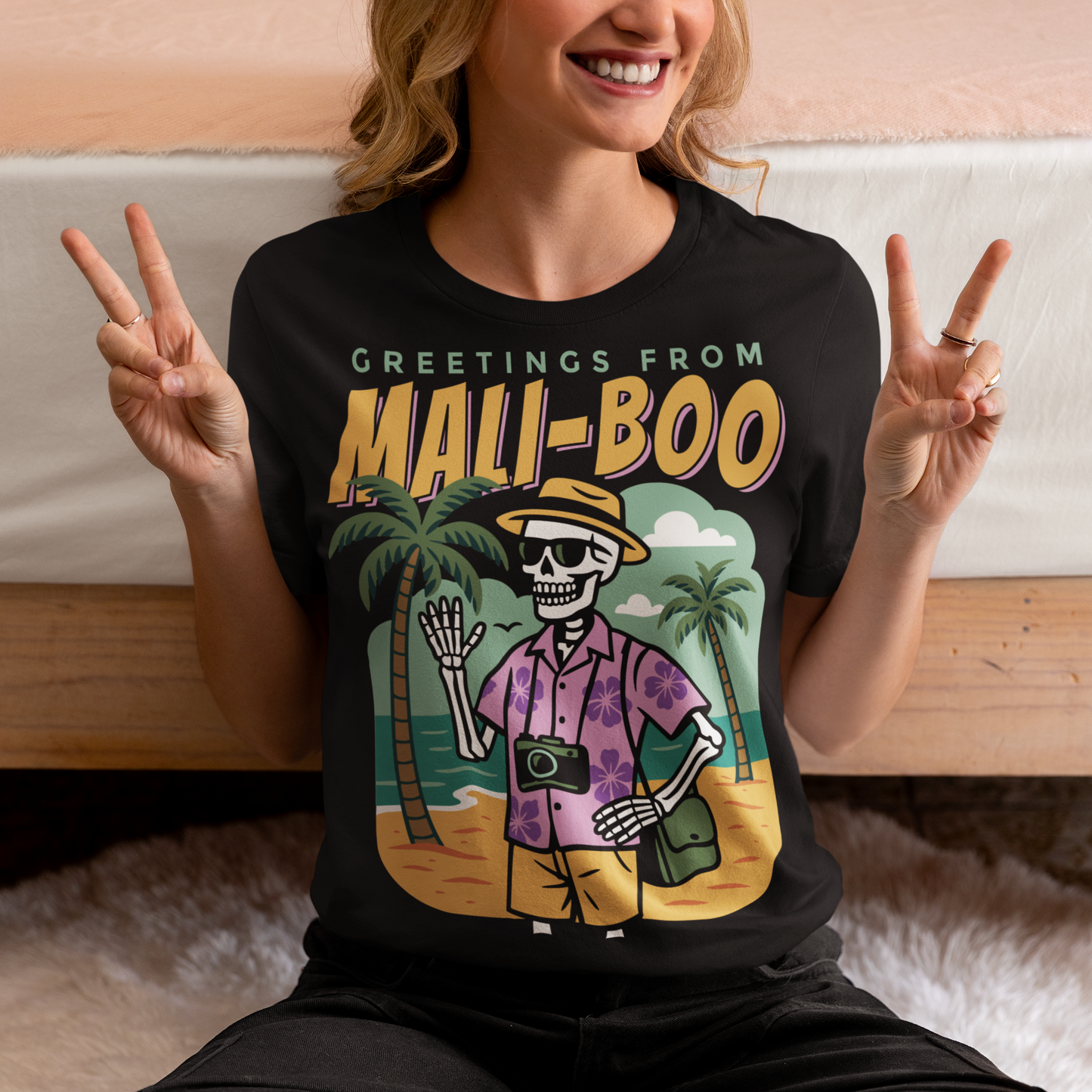 Bring spooky vibes to the sunshine with our “Greetings from Mali-Boo” Skeleton Tee. Featuring a laid-back skeleton kicking back on the beach, this shirt blends Halloween humor with tropical holiday fun. Perfect for anyone who loves a good pun, it’s a playful mash-up of palm trees, sandy shores, and ghostly charm. Lightweight, soft, and eye-catching, this tee is your go-to for summer parties, Halloween hangouts, or just showing off your wicked sense of humor.