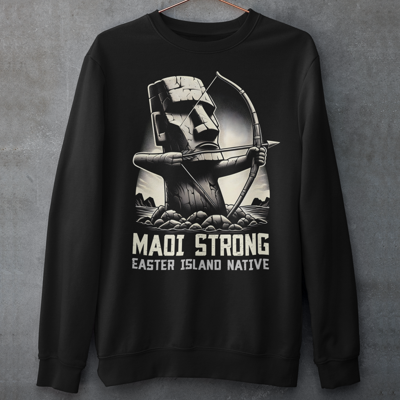 This bold sweatshirt design features a dynamic illustration of a Moai statue, iconic to Easter Island, standing tall and proud. The Moai is depicted holding a bow and arrow, symbolizing strength and resilience. The statue is detailed with strong, angular lines and stone textures, giving it an authentic yet artistic appearance. Beneath the striking image, the text reads in bold, capitalized letters: "MAOI STRONG EASTER ISLAND NATIVE."