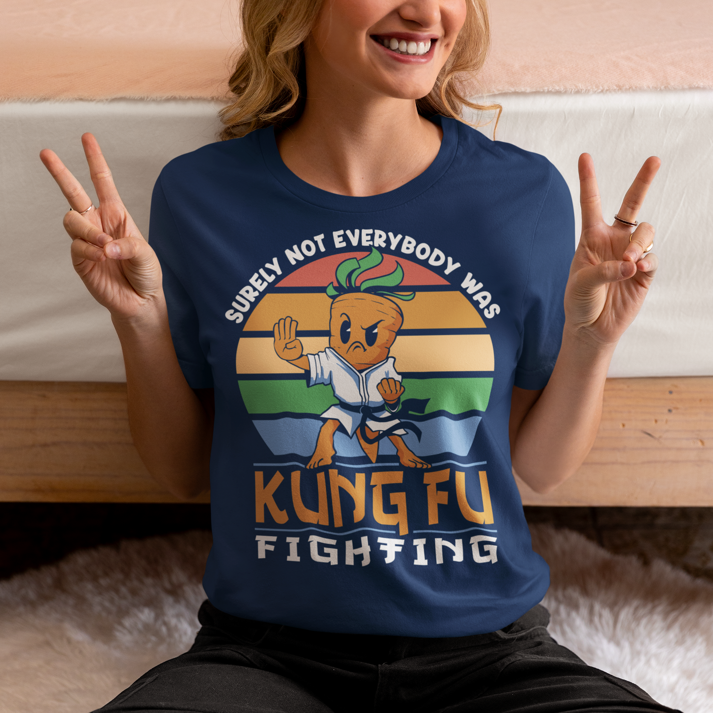 Introducing our vibrant and whimsical "Kung Fu Carrot" T-shirt, a perfect blend of humor and retro flair that's sure to turn heads! This unique design features a fearless carrot assuming a kung fu stance against the backdrop of a mesmerizing retro sun. The carrot's determined expression and martial arts pose exude confidence and playfulness. Surrounding this dynamic scene is the iconic phrase "SURELY NOT EVERYBODY WAS KUNG FU FIGHTING,".