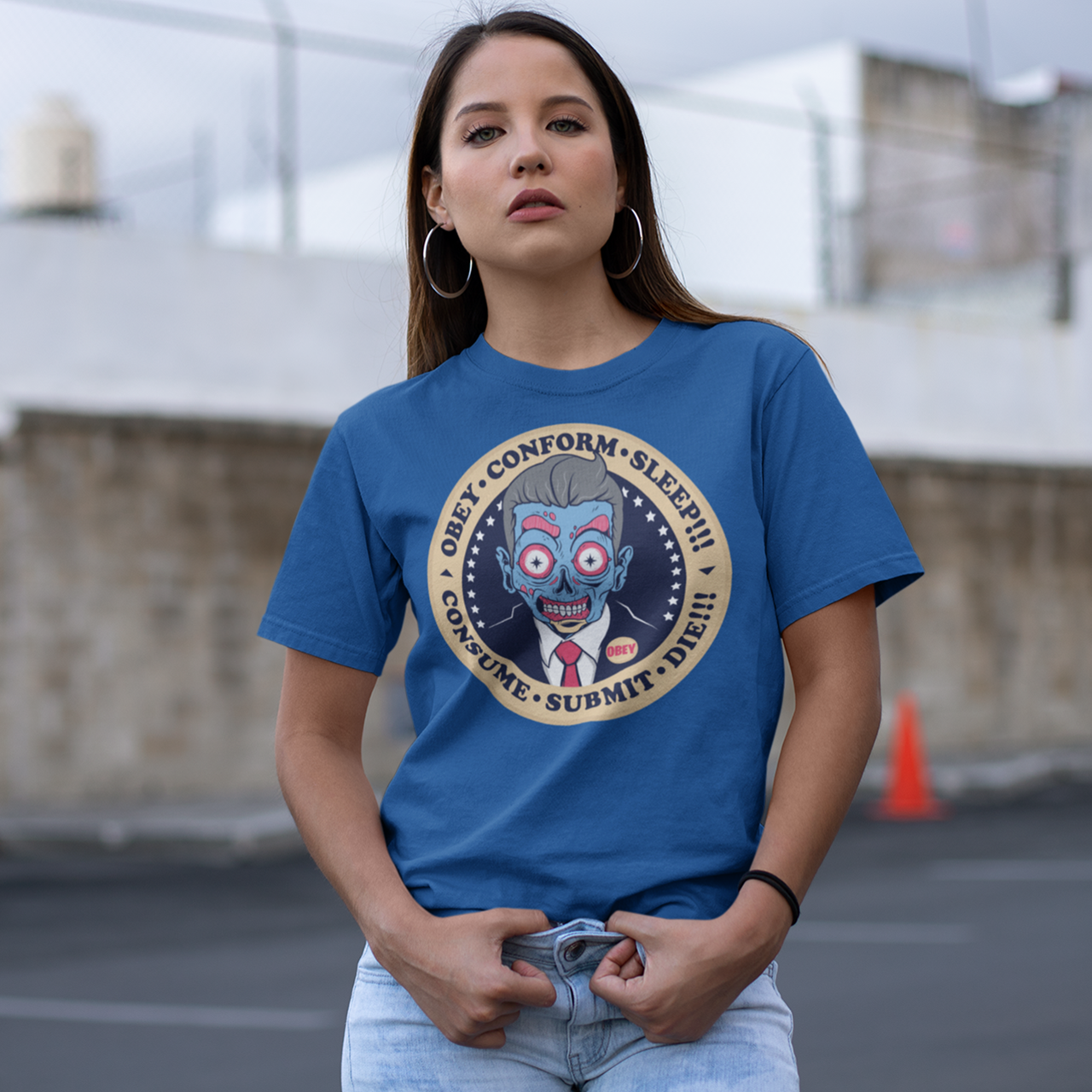 Royal blue t-shirt with alien president with text "OBEY, CONFORM, SLEEP, CONSUME, SUBMIT".