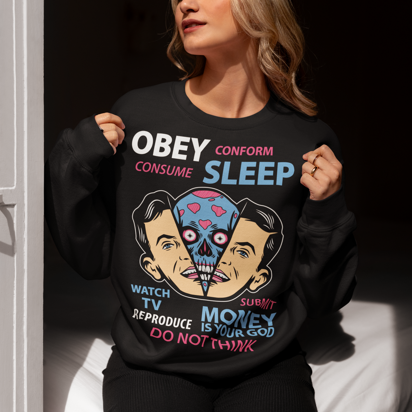 Introducing our bold and thought-provoking sweatshirt design, featuring an extraterrestrial creature removing a human face with the words "Obey, Submit, Conform, Consume, Money is your God" boldly emblazoned across the front. This striking design serves as a powerful reminder of the dangers of blindly following societal norms and expectations, and the all-consuming nature of money and consumerism in our modern world.