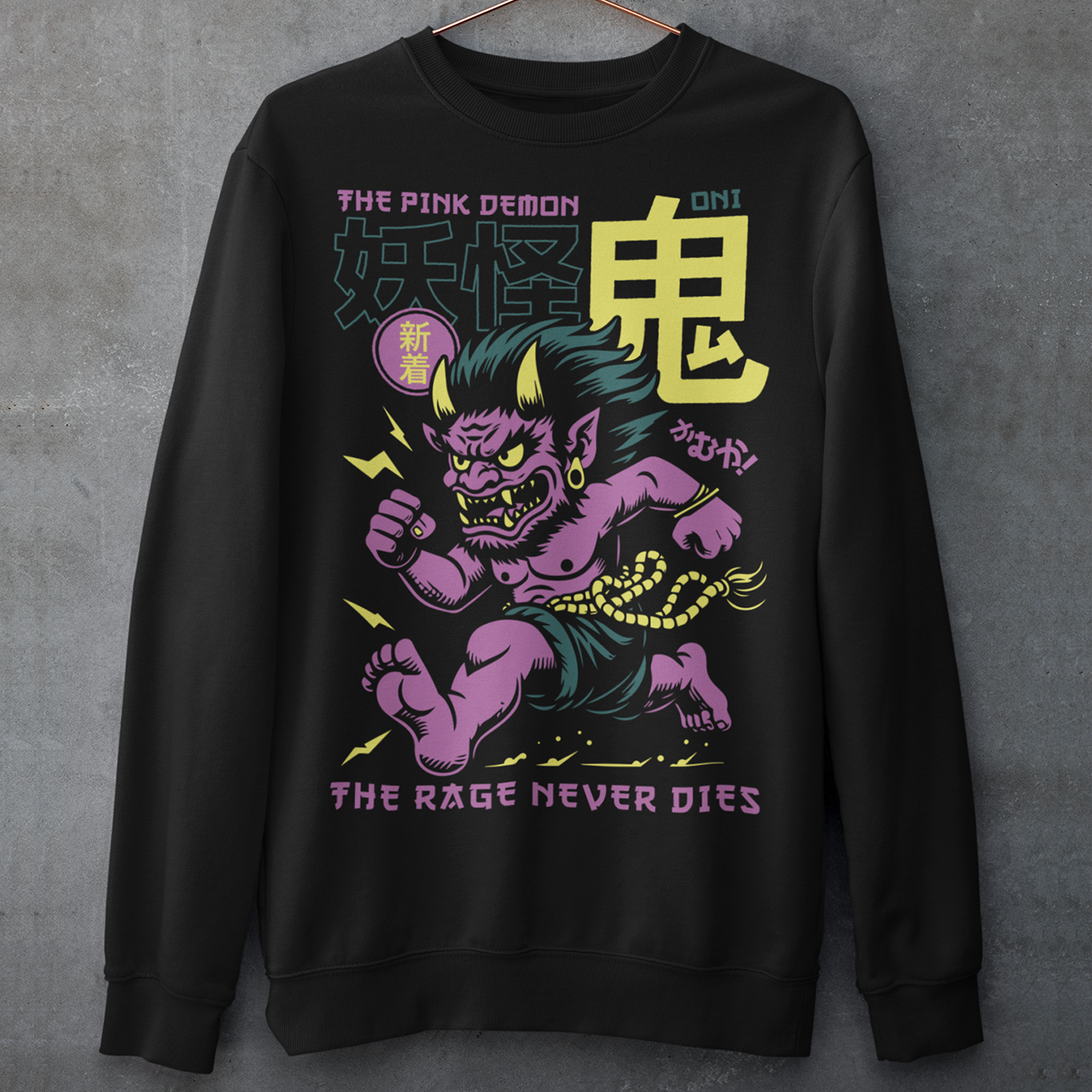 Bold, fierce, and unstoppable — this dynamic sweatshirt features a powerful Japanese Oni mid-sprint, eyes blazing and muscles tense with fury. Above the image, bold text declares "THE PINK DEMON", while below, a chilling reminder reads: "THE RAGE NEVER DIES". This shirt captures the raw energy and mythic wrath of the Oni spirit — perfect for those who embrace intensity and never back down.
