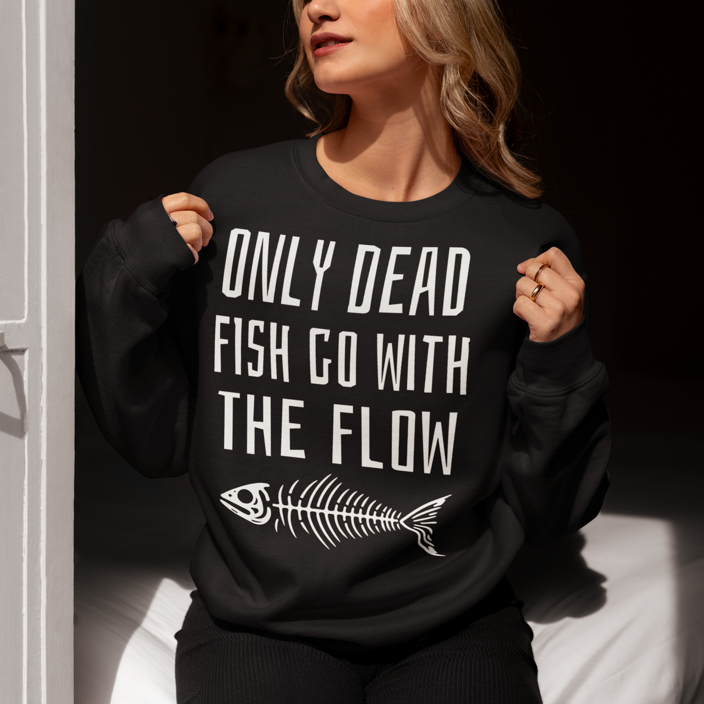 Introducing our bold and thought-provoking sweatshirt that features a striking design: a fish skeleton, paired with the empowering message "ONLY DEAD FISH GO WITH THE FLOW." This sweatshirt is perfect for those who pride themselves on swimming against the tide and embracing their individuality. The fish skeleton, rendered in a minimalist yet impactful style, symbolizes the importance of standing out and making your own path.