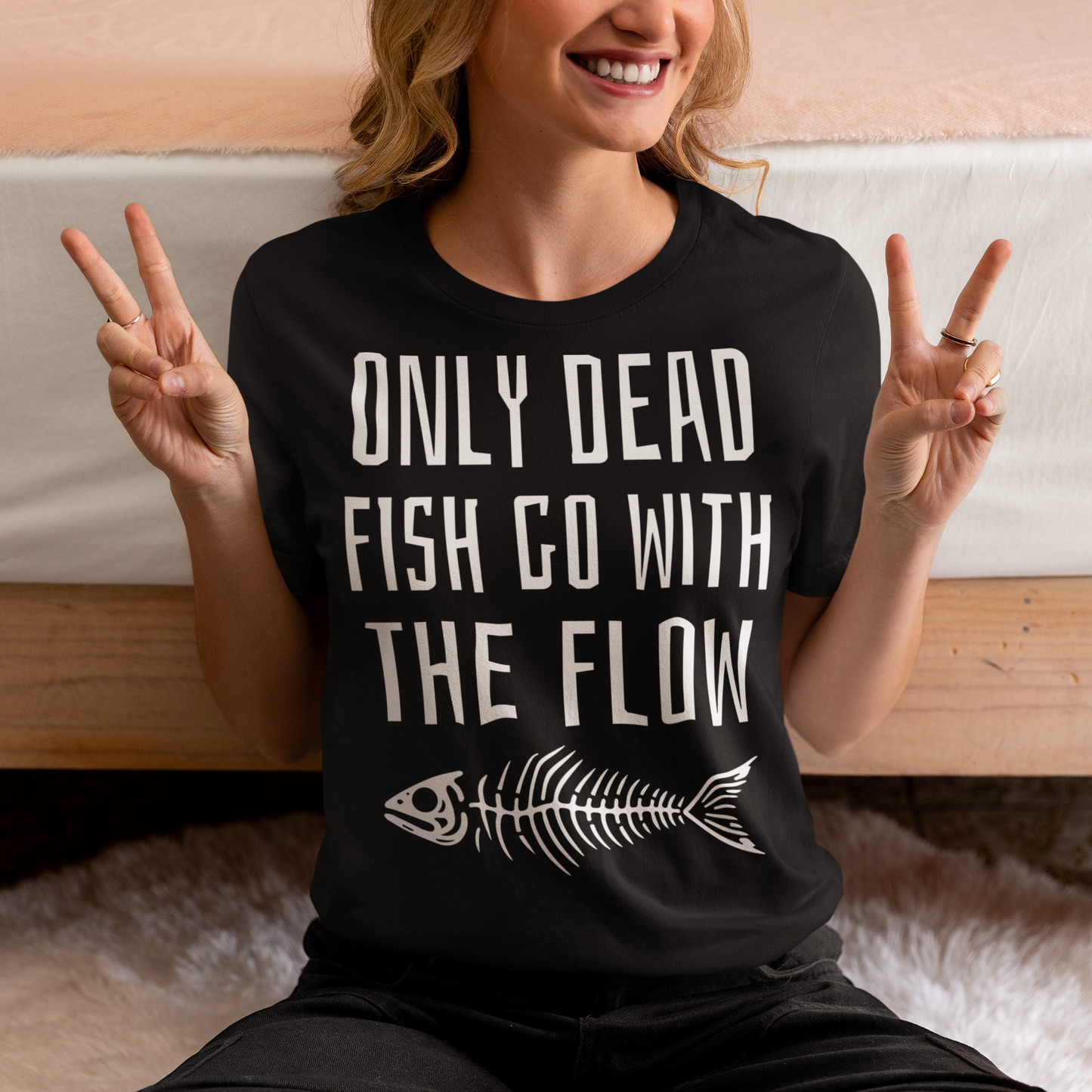 Introducing our bold and thought-provoking t-shirt that features a striking design: a fish skeleton, paired with the empowering message "ONLY DEAD FISH GO WITH THE FLOW." This tee is perfect for those who pride themselves on swimming against the tide and embracing their individuality. The fish skeleton, rendered in a minimalist yet impactful style, symbolizes the importance of standing out and making your own path.