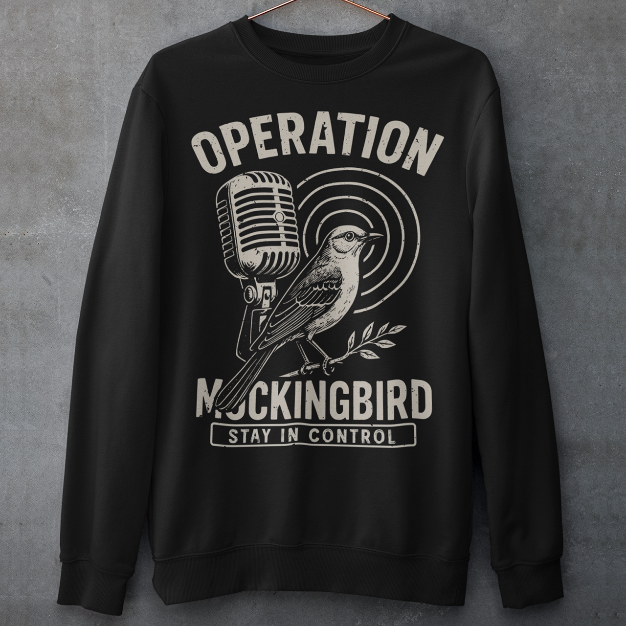 Celebrate a fascinating piece of Cold War history with this Operation Mockingbird sweatshirt. Featuring a sleek graphic of a mockingbird perched on a microphone, the design nods to the program that sought to influence news media during the mid-20th century. Perfect for history enthusiasts, political science buffs, and anyone who loves thought-provoking apparel.