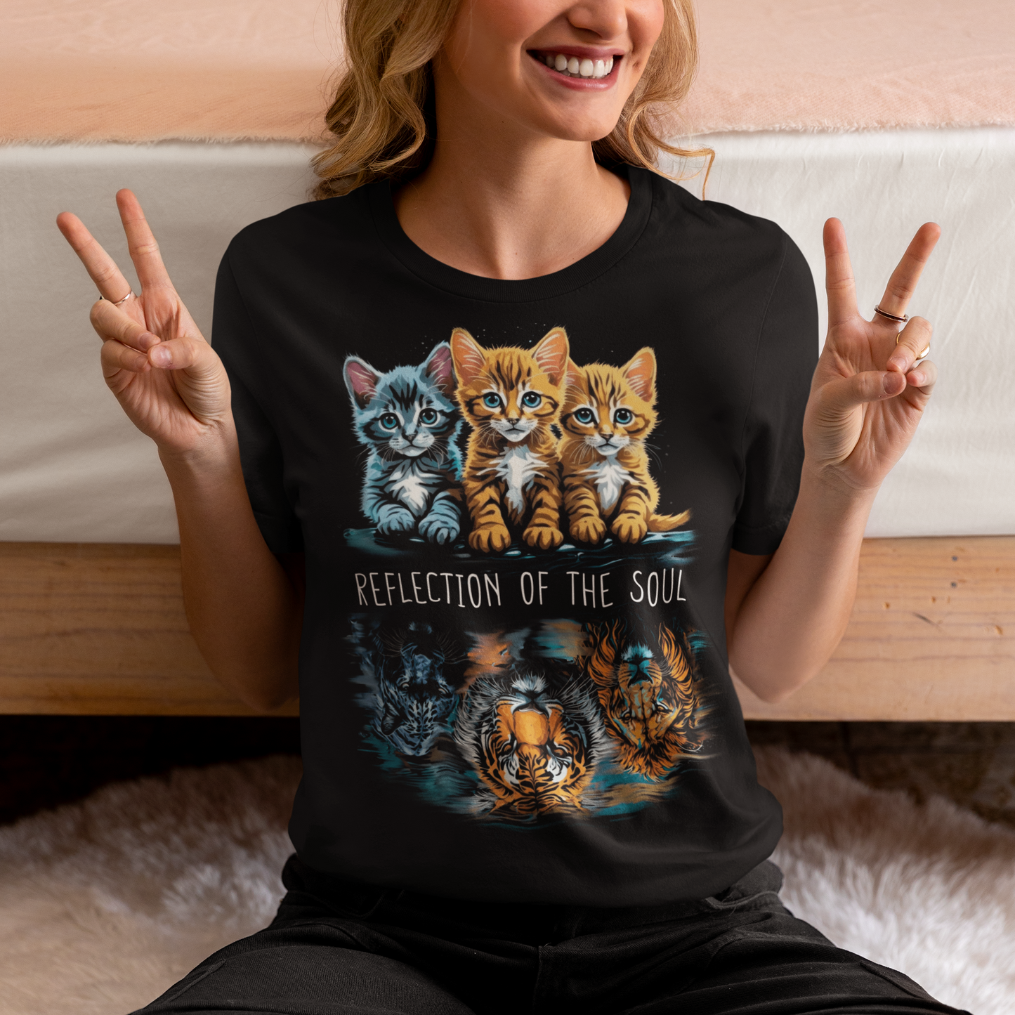 The design on this t-shirt is a captivating depiction of three cats, each gazing at their reflection in the water. Positioned in front of them are the majestic figures of a lion, a panther, and a tiger, their images rippling in the tranquil surface. The cats appear transfixed, their eyes filled with curiosity and introspection as they peer into the depths. In the center of the design, bold text reads "REFLECTION OF THE SOUL," drawing attention to the profound theme of self-awareness and inner contemplation