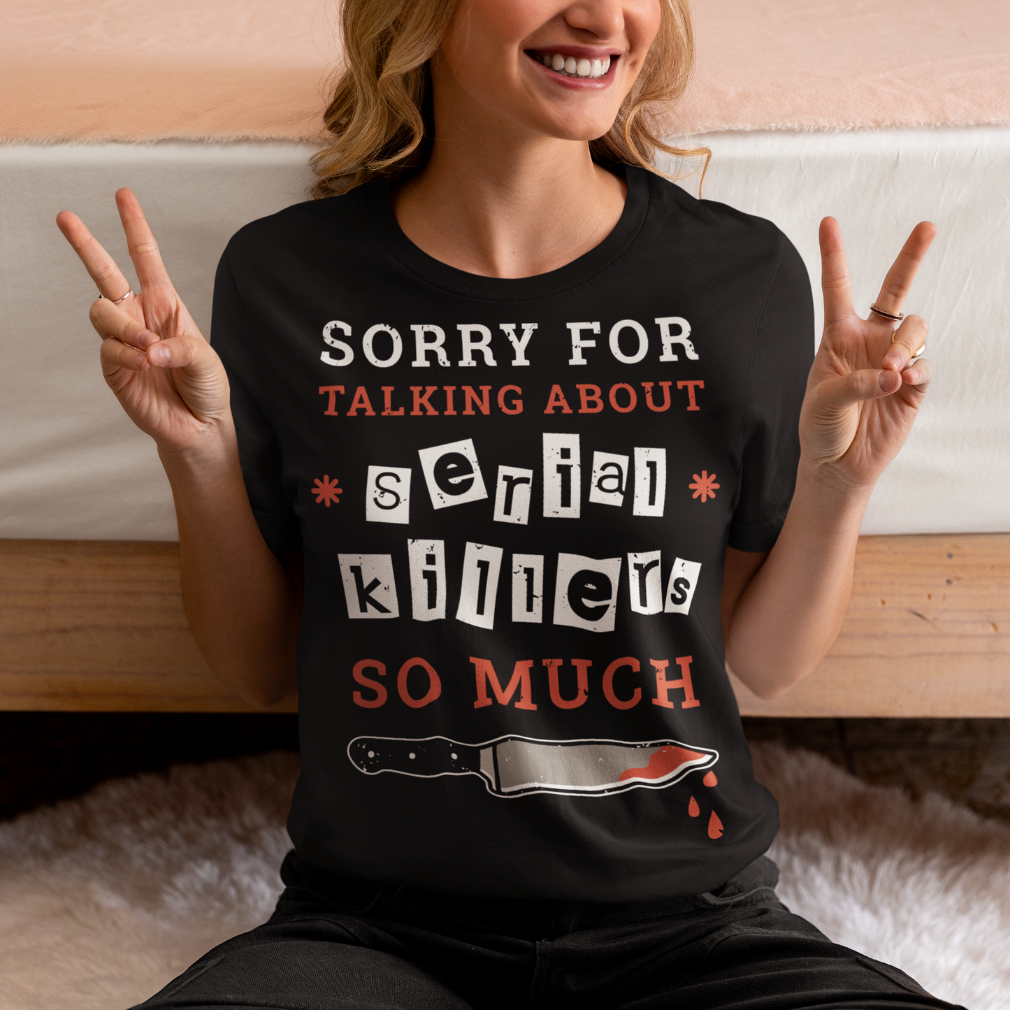 The t-shirt features a humorous and slightly self-deprecating message that reads "SORRY FOR TALKING ABOUT SERIAL KILLERS SO MUCH". The text is printed in bold, white and red letters on a solid-colored background, creating a striking contrast that catches the eye. The design is simple yet effective, making it perfect for anyone who has a penchant for true crime and likes to engage in conversations about serial killers.